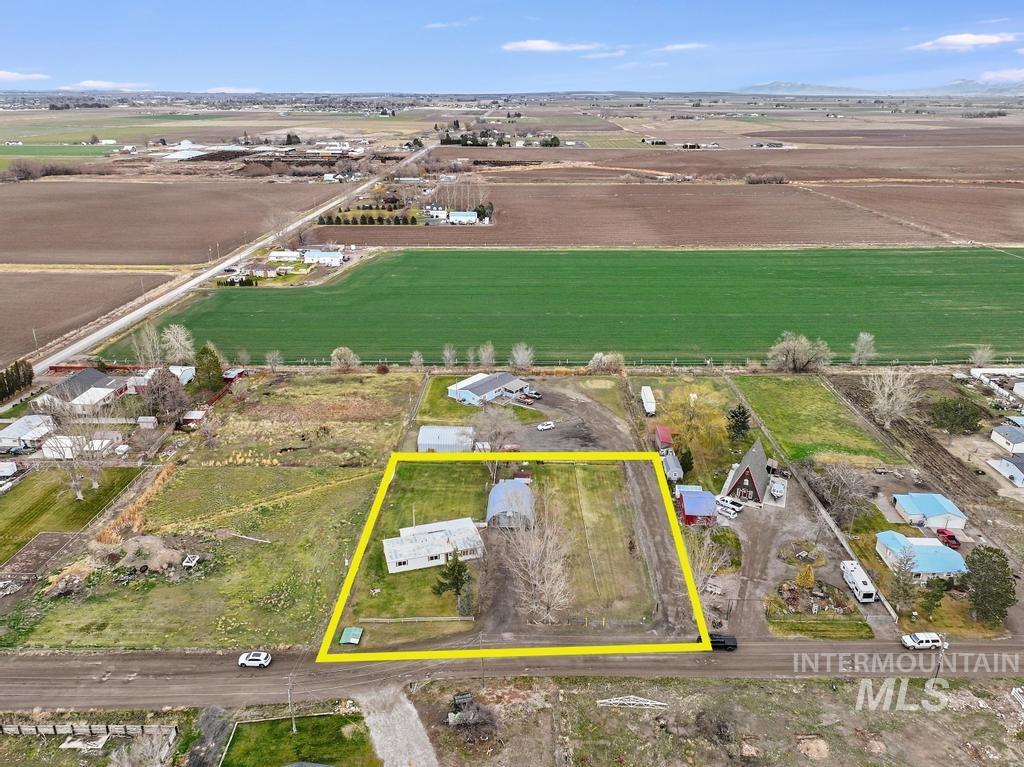 View of rural area featuring property parcel outlined and farmland