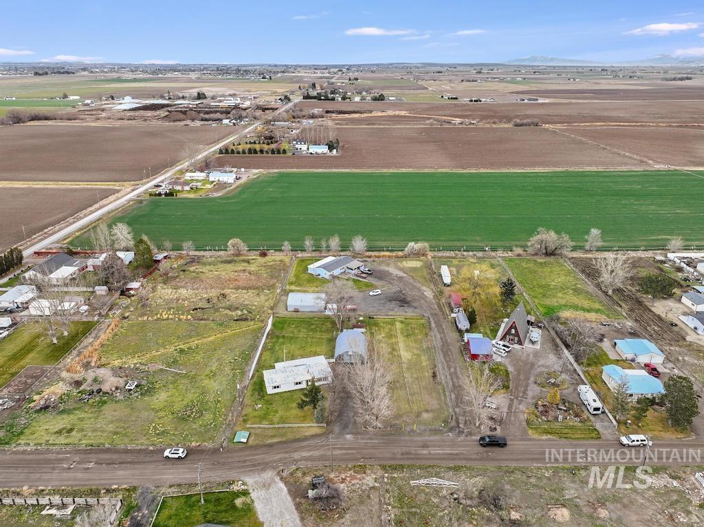 Aerial overview of property's location featuring rural landscape and farmland