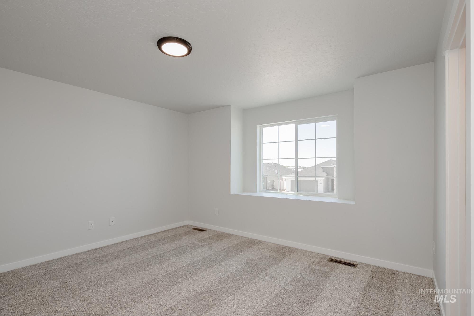 Unfurnished room with light carpet and baseboards