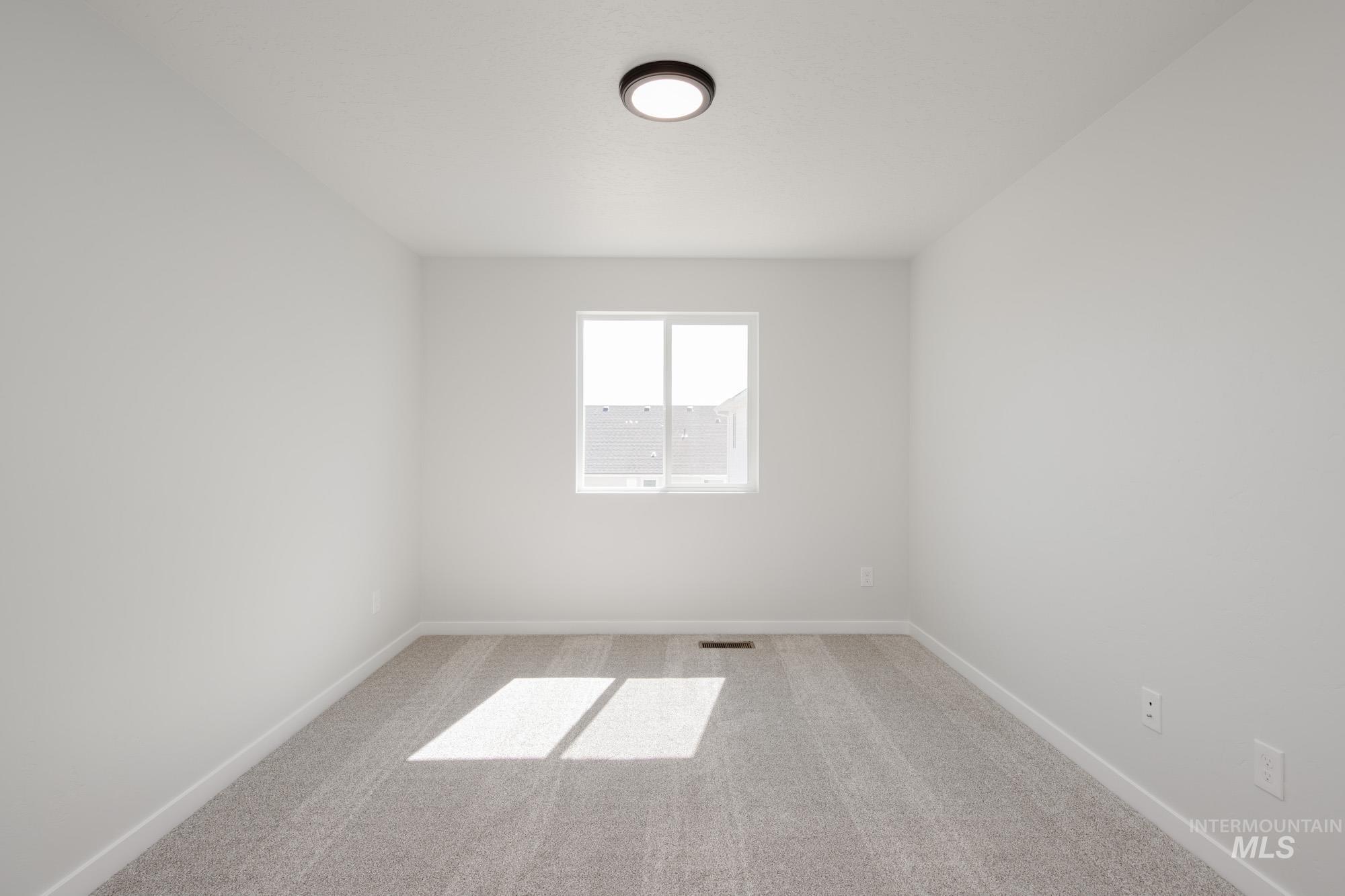 Unfurnished room with carpet flooring and baseboards