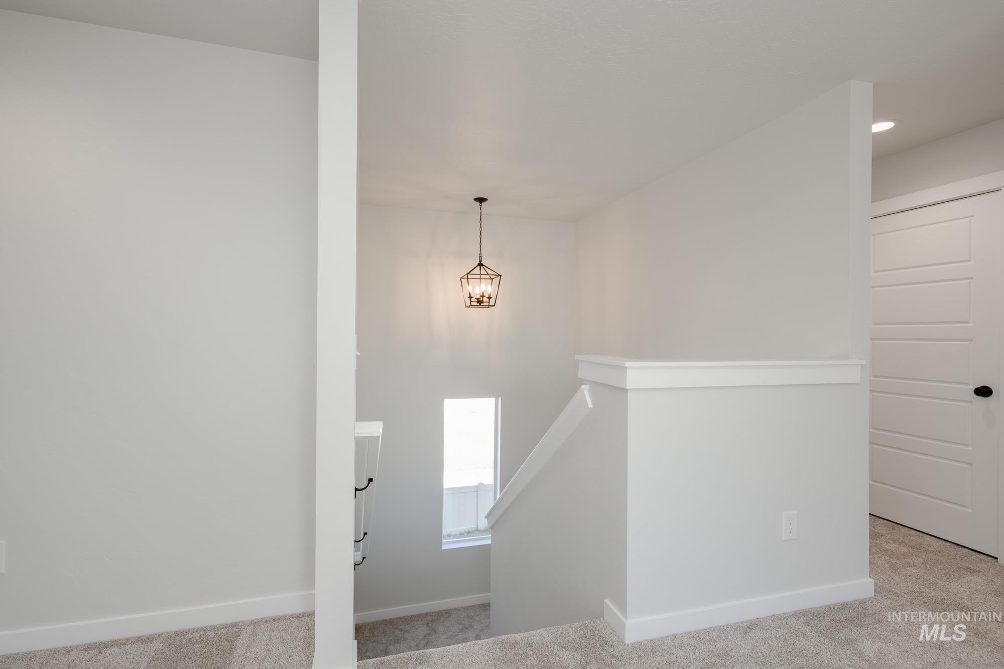 Staircase featuring carpet floors and baseboards