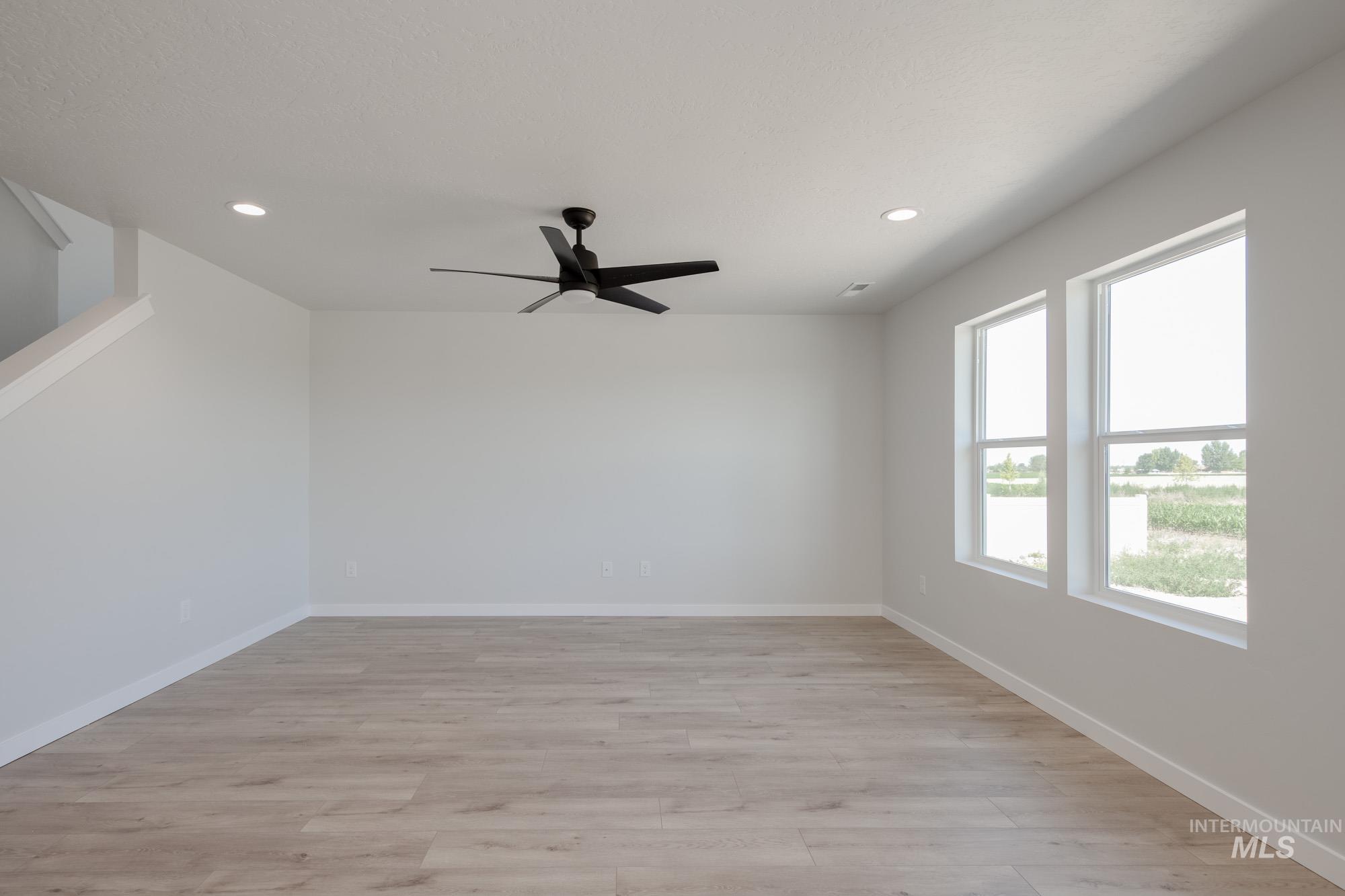 Spare room with light wood-style floors, recessed lighting, and a ceiling fan
