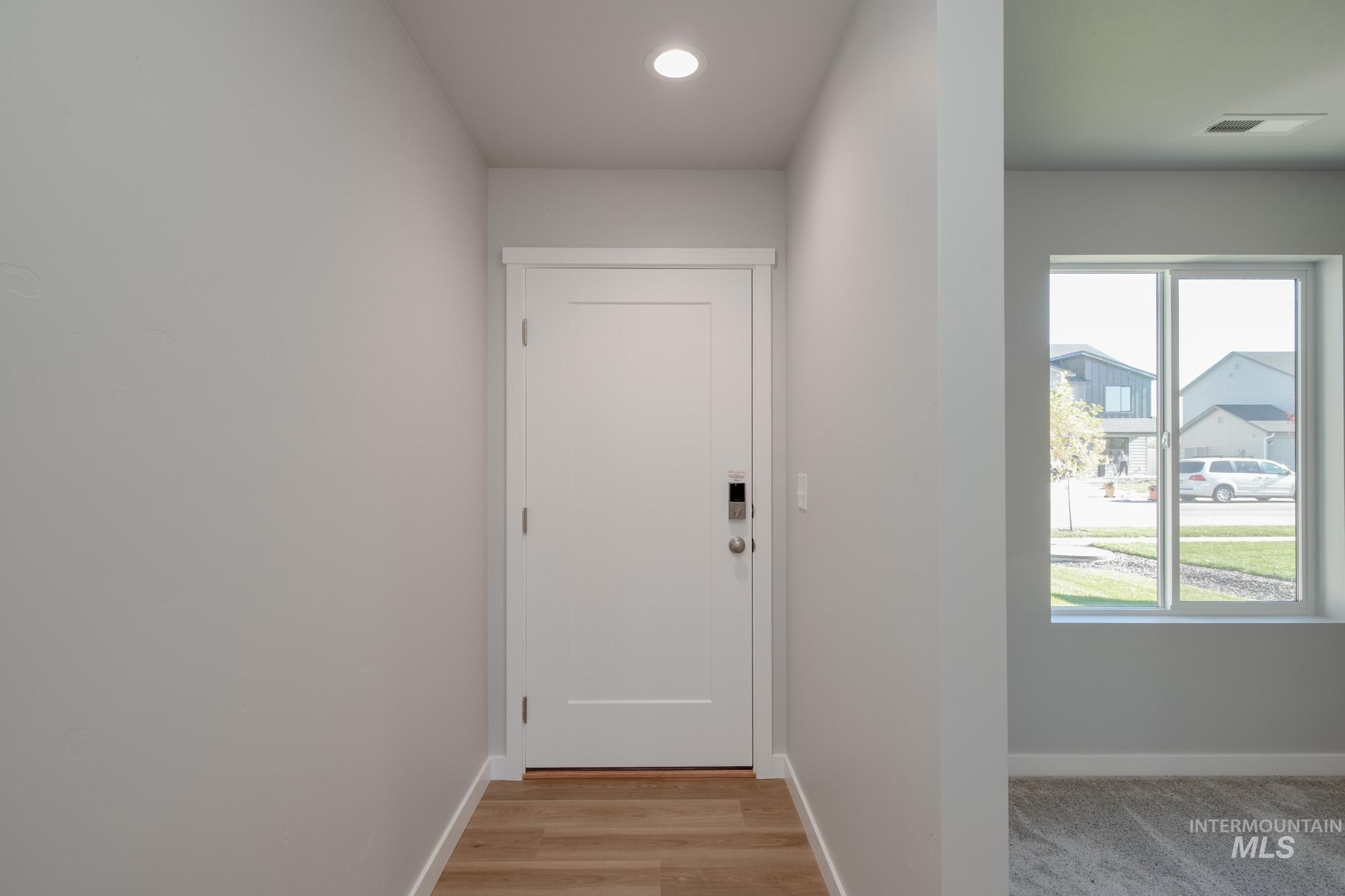 Entryway featuring baseboards and recessed lighting