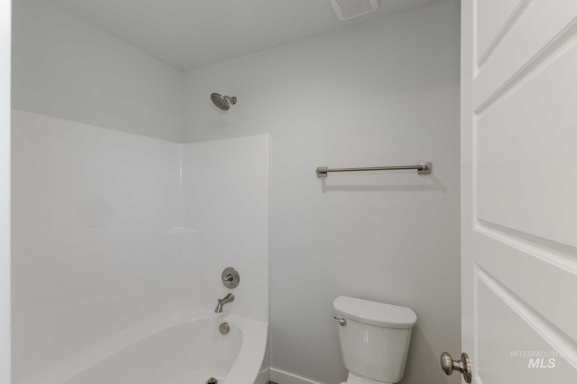 Full bath featuring washtub / shower combination and toilet