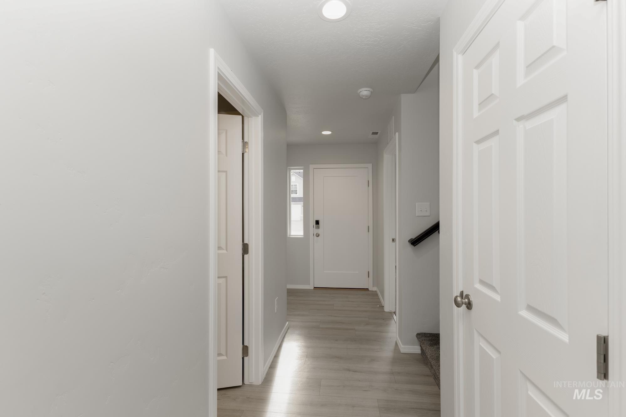 Hallway with recessed lighting and light wood-style floors