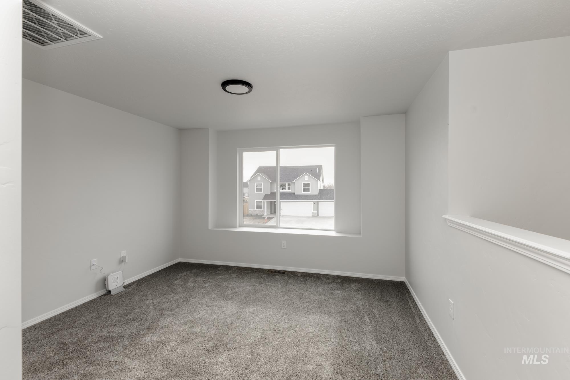 Unfurnished room with carpet flooring and baseboards