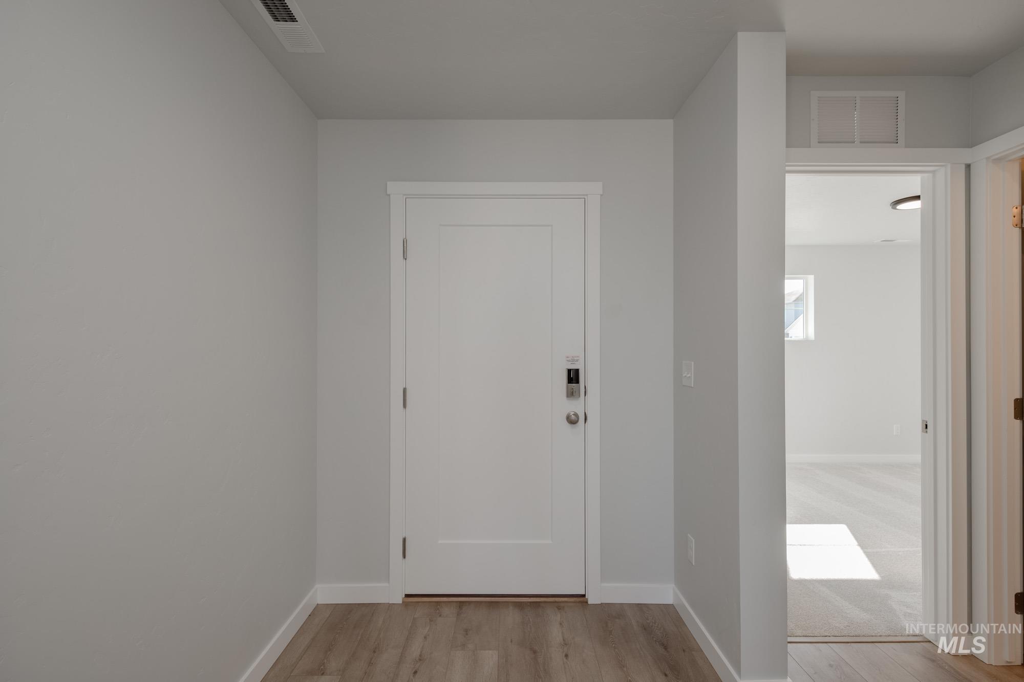 Foyer entrance with baseboards and light wood finished floors