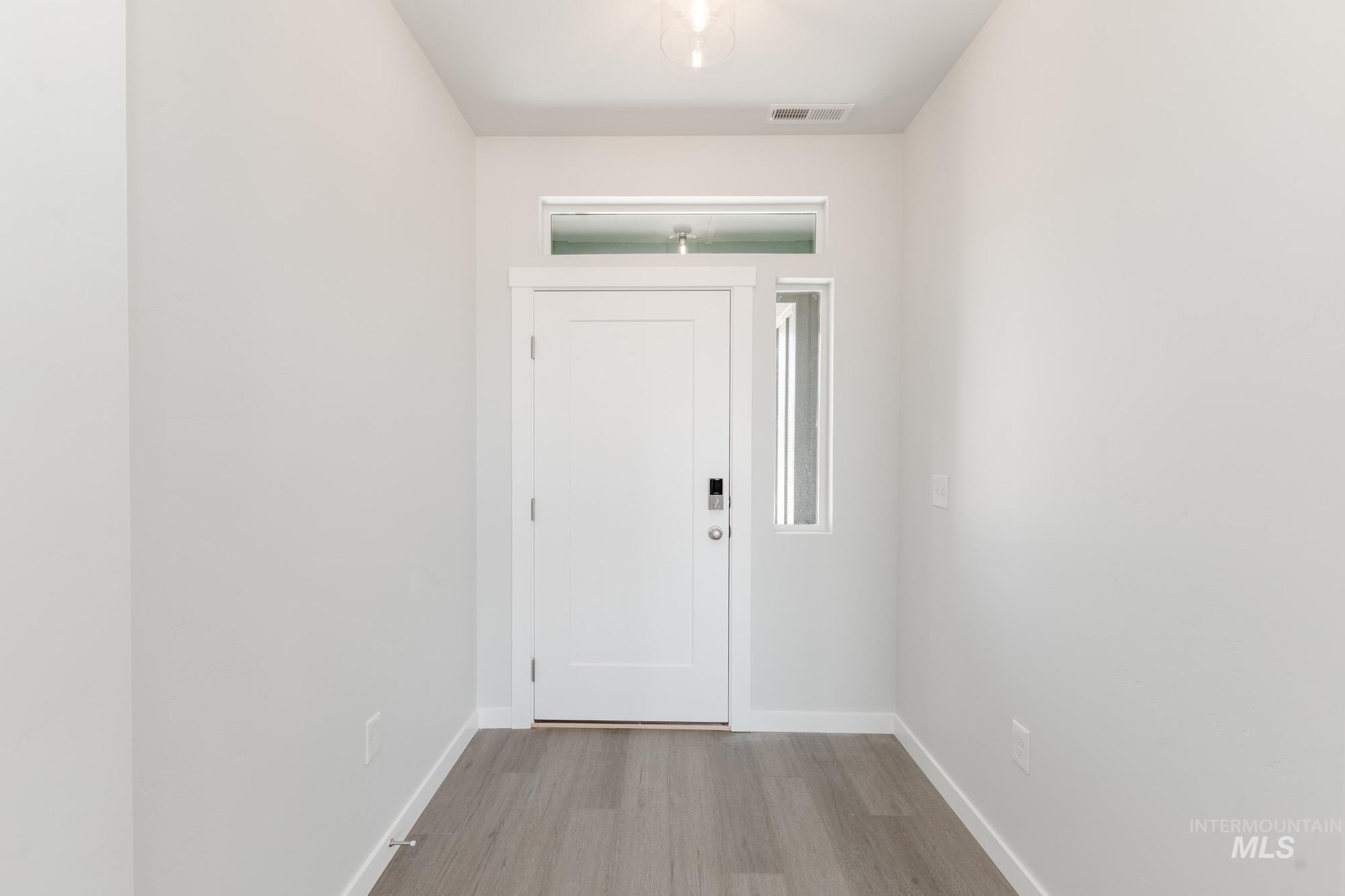 Foyer entrance featuring baseboards and light wood finished floors