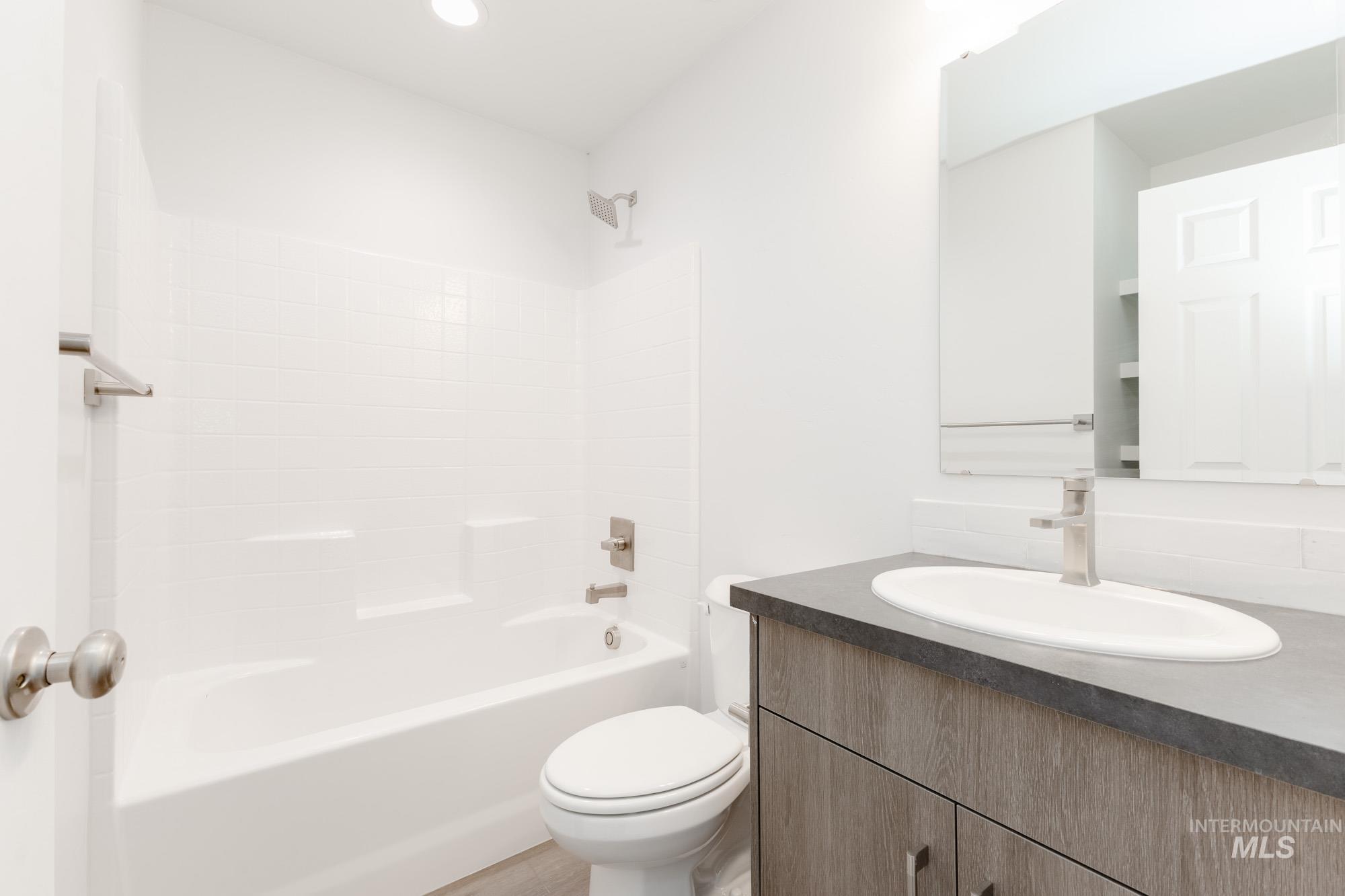 Full bath featuring vanity and shower / bathtub combination