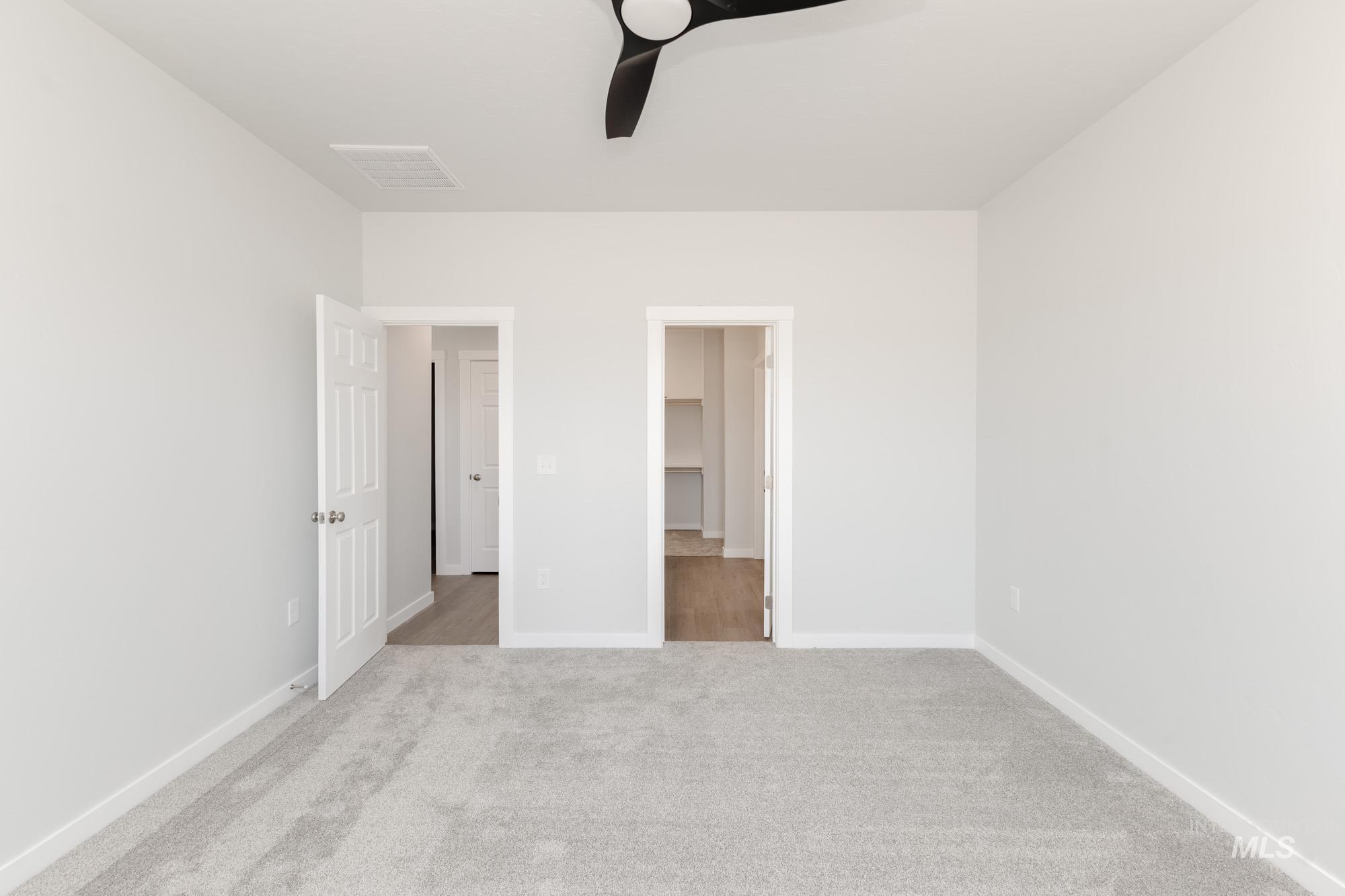 Unfurnished bedroom featuring ceiling fan and light carpet