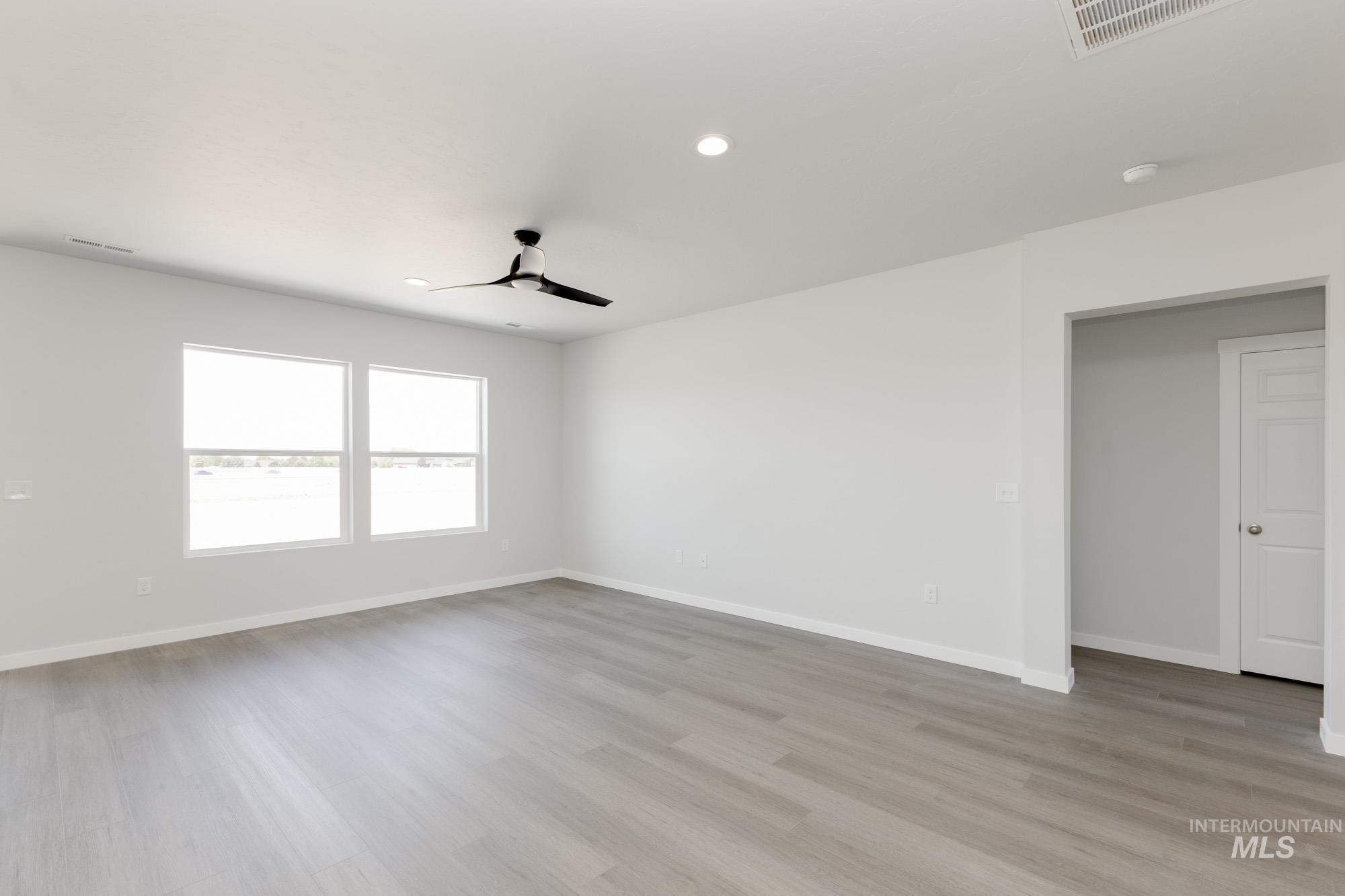 Empty room with recessed lighting, light wood-type flooring, and a ceiling fan