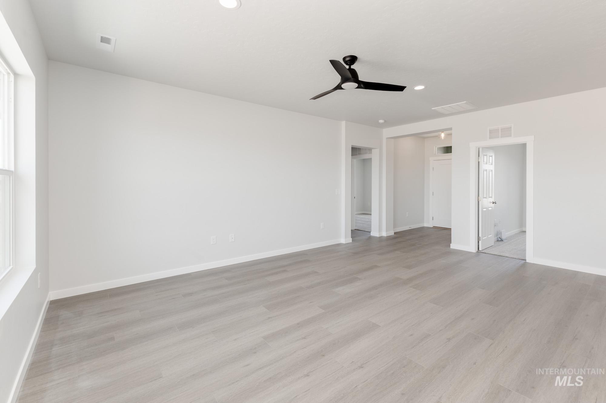 Unfurnished bedroom featuring ceiling fan, light wood-style flooring, and recessed lighting
