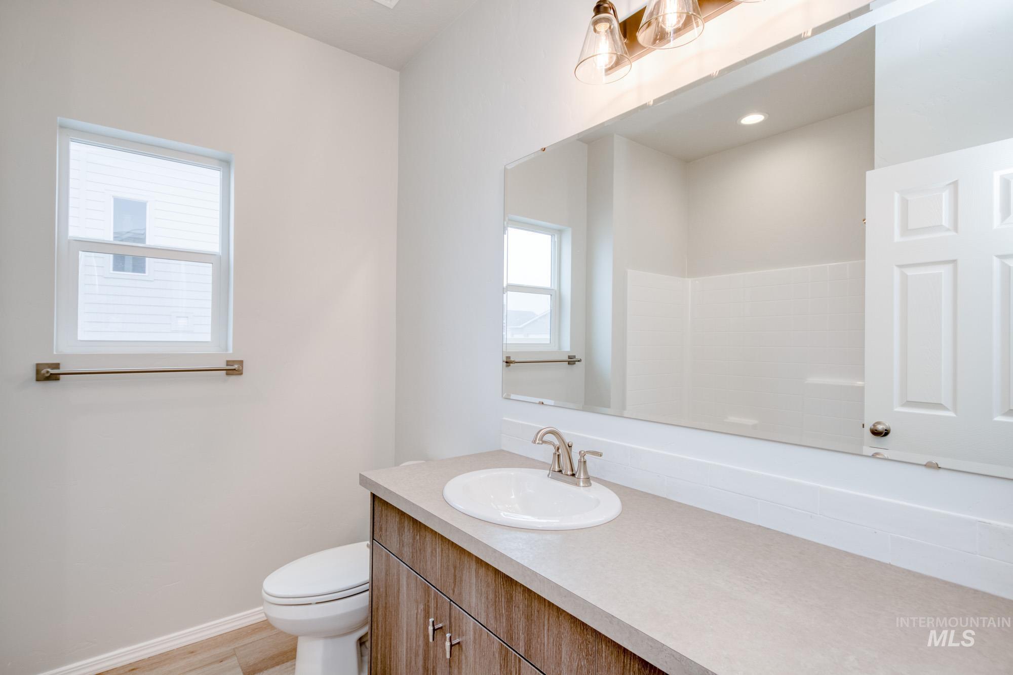 Full bathroom featuring vanity and light wood-style flooring