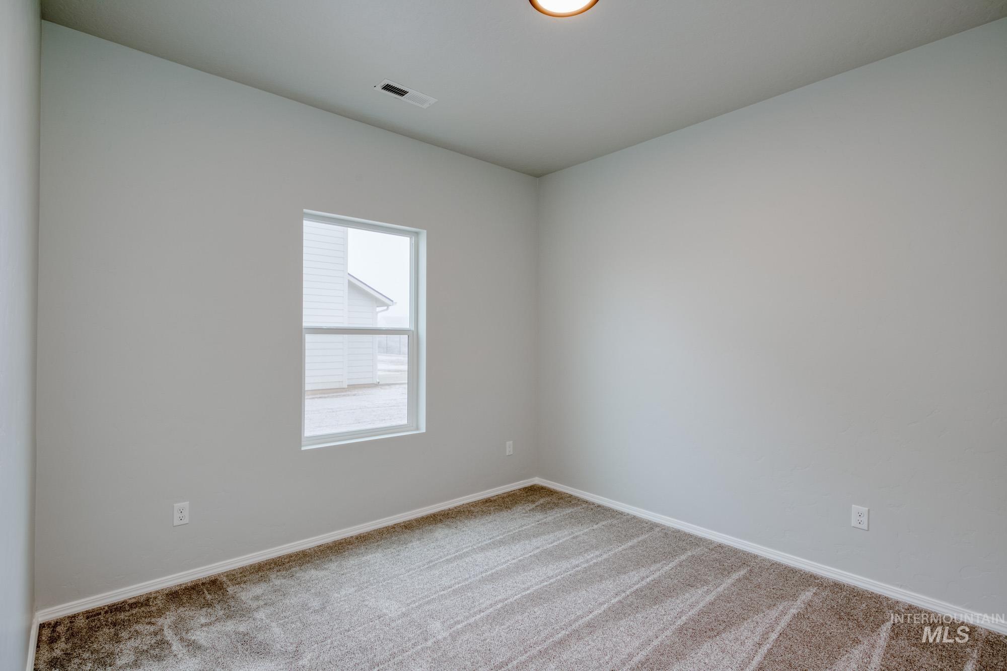 Unfurnished room with carpet floors and baseboards