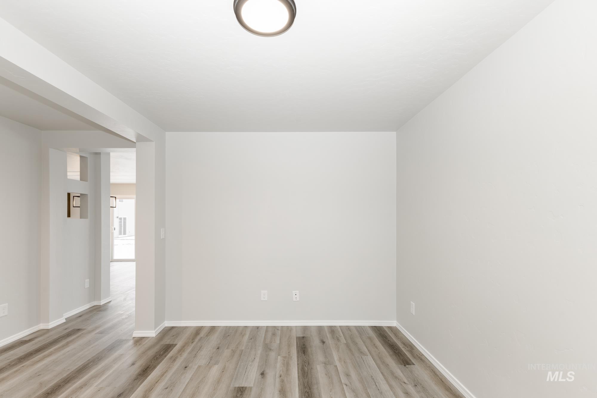 Unfurnished room featuring baseboards and light wood-style floors