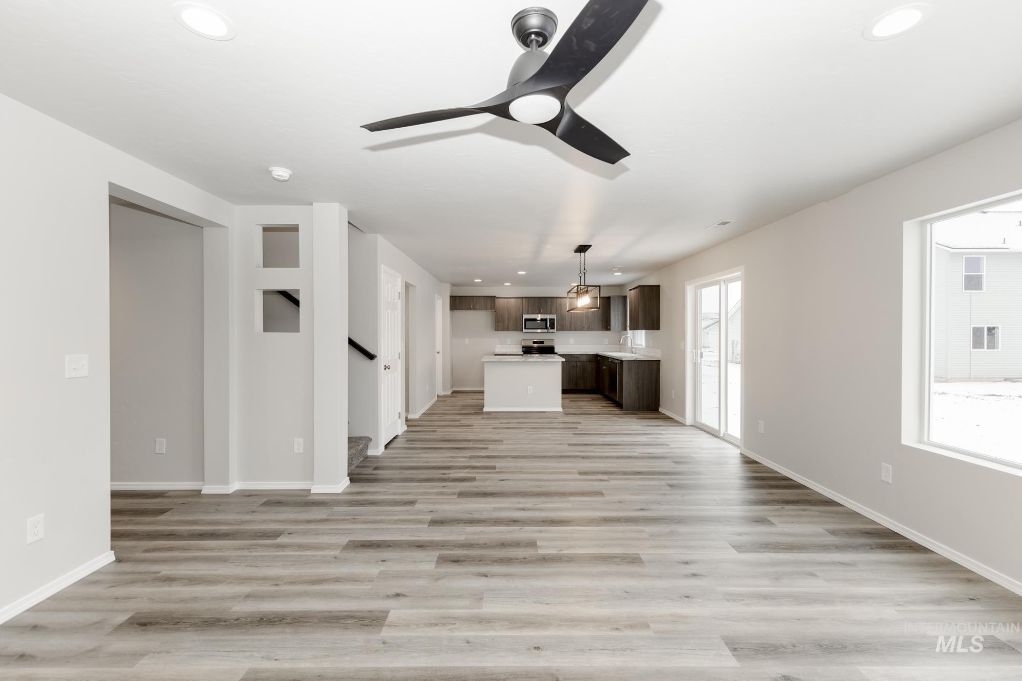 Unfurnished living room featuring recessed lighting, light wood-style flooring, and ceiling fan