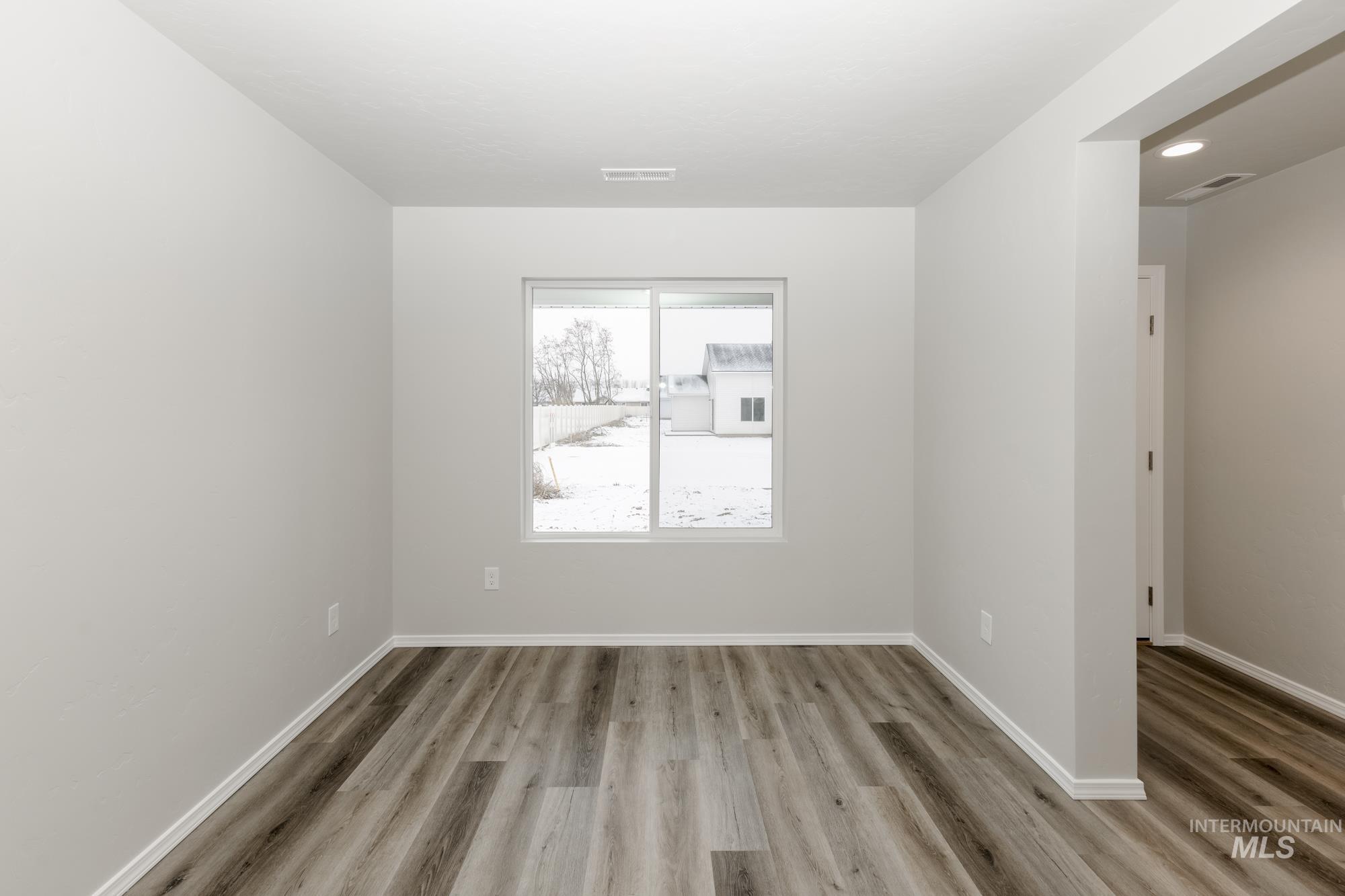 Unfurnished room featuring baseboards and light wood-type flooring