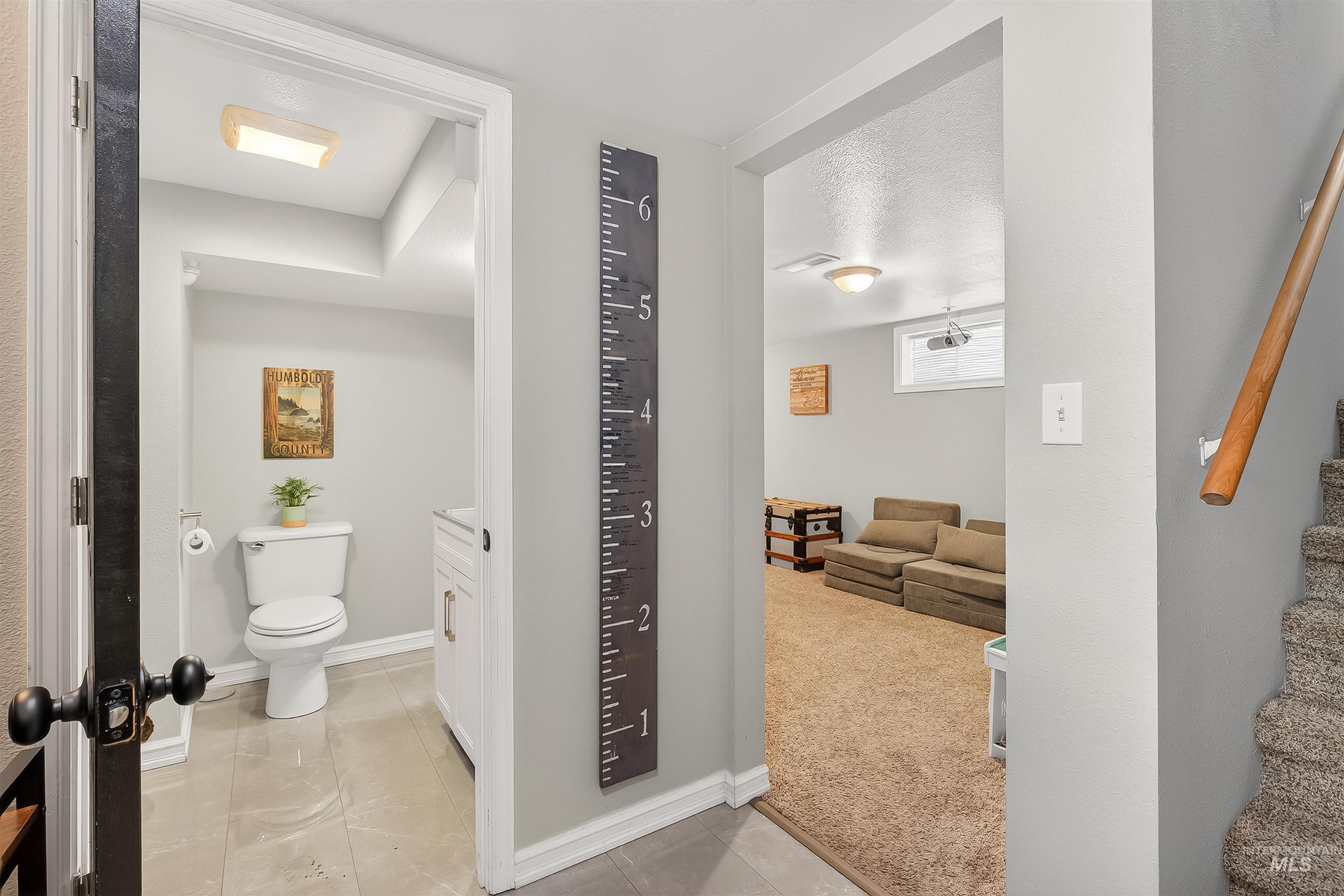 Bathroom featuring light colored carpet and vanity