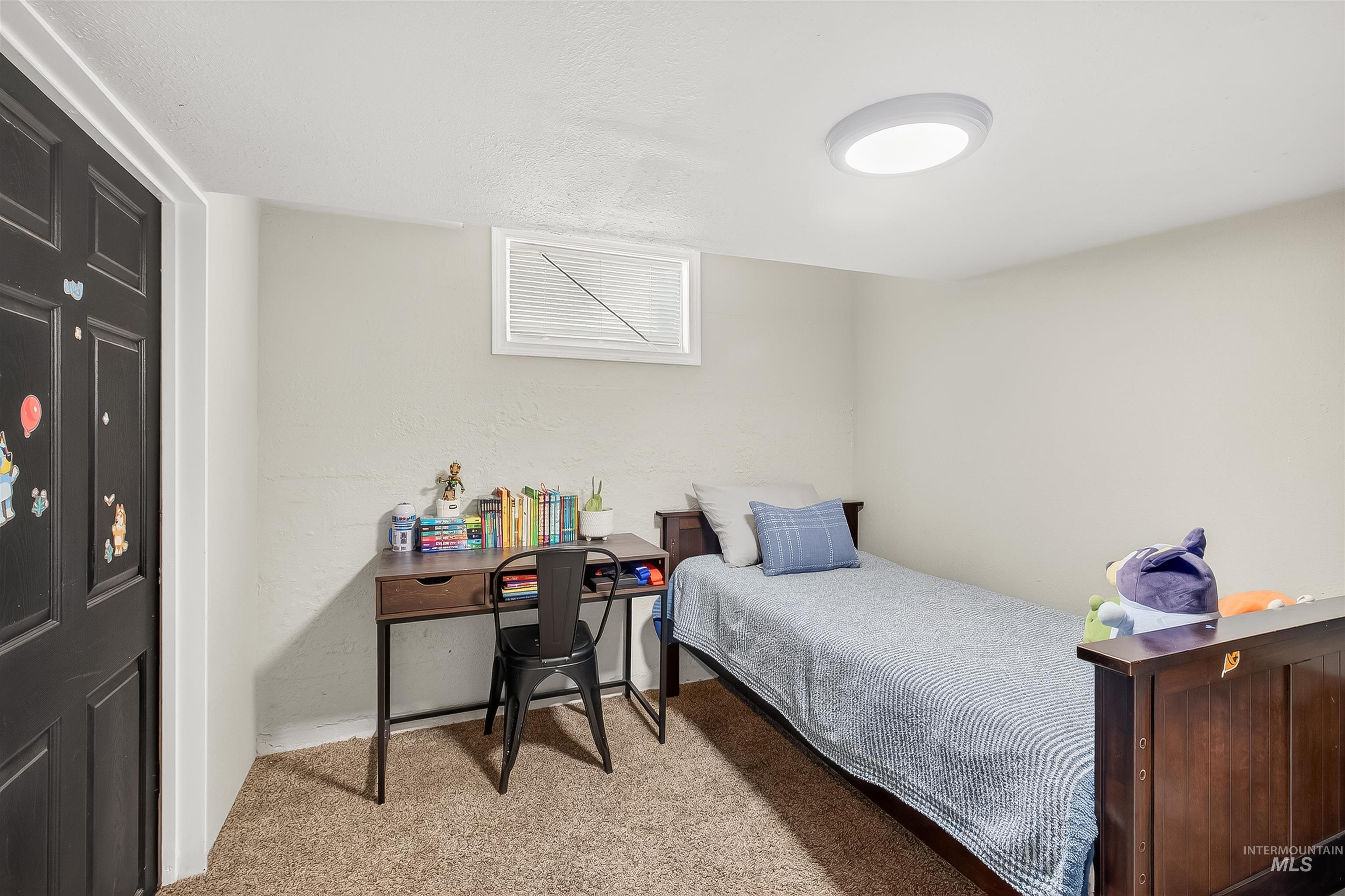Bedroom featuring light colored carpet and baseboards