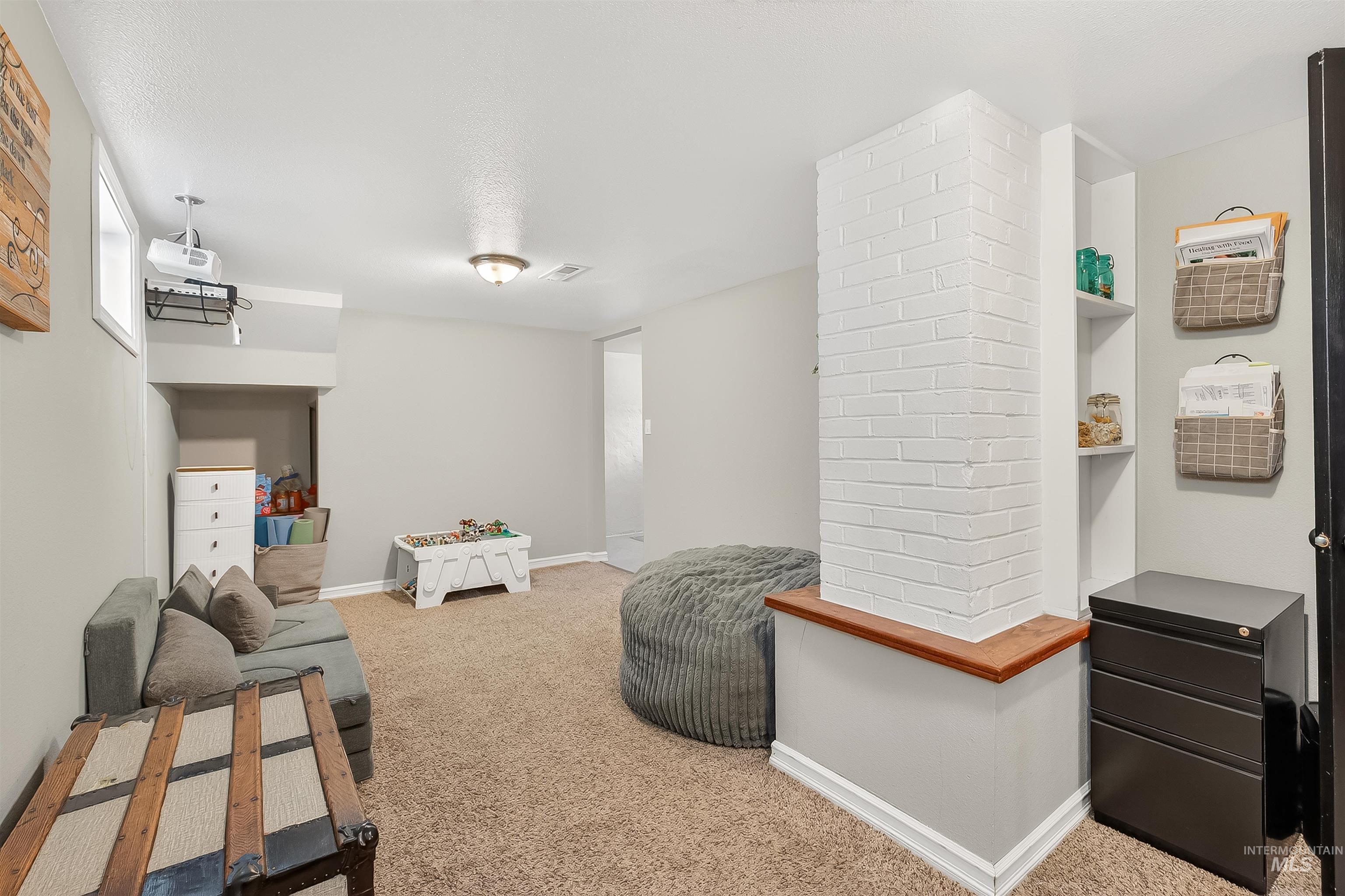Living area featuring baseboards and carpet floors