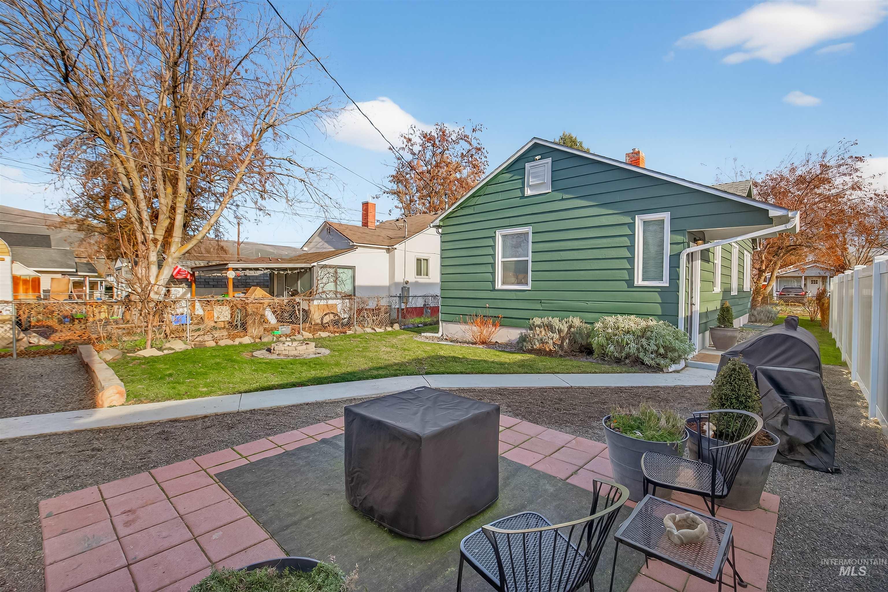 Back of house featuring a fenced backyard, a patio, and a chimney