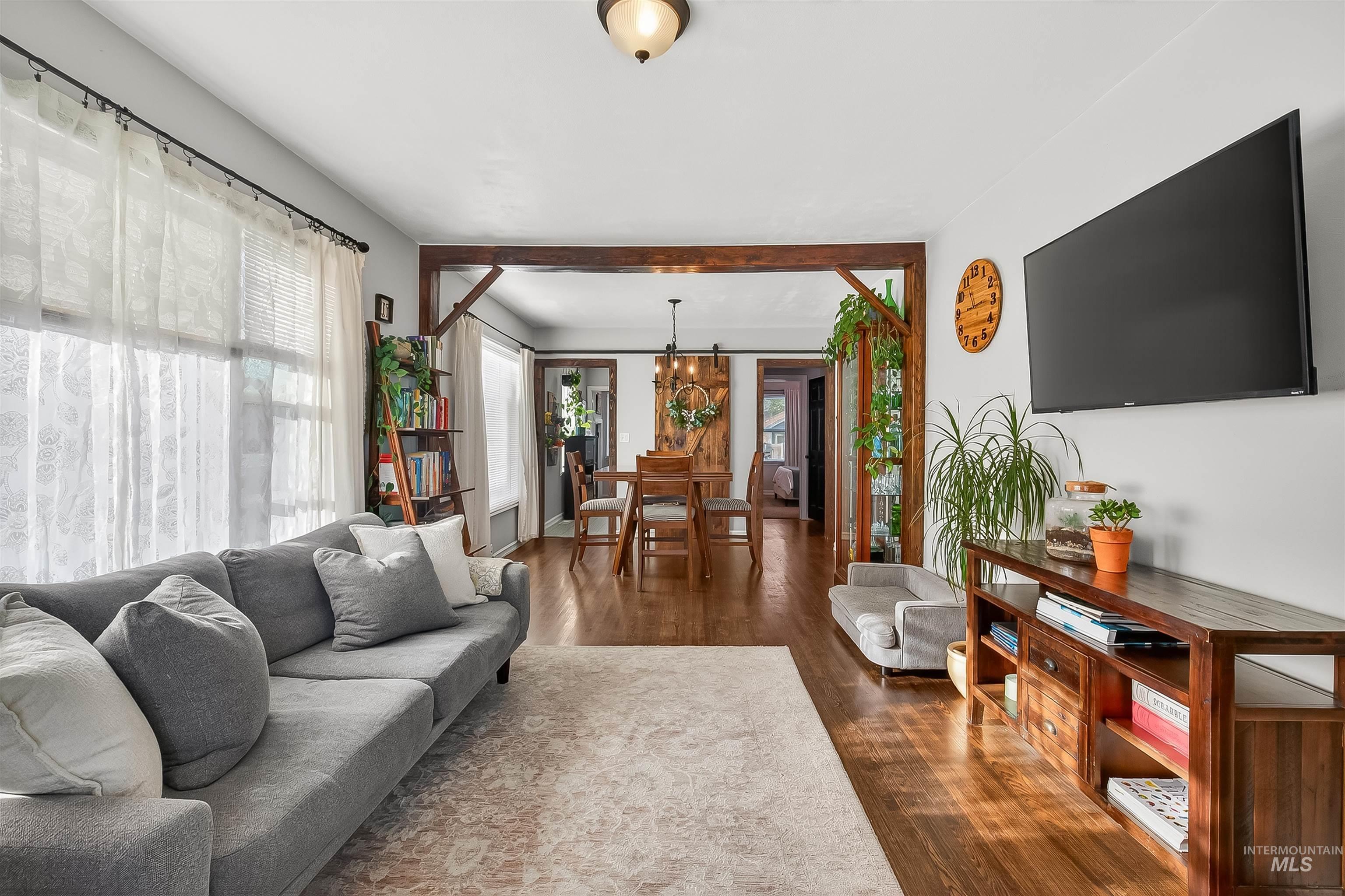 Living room with dark wood-style floors and plenty of natural light