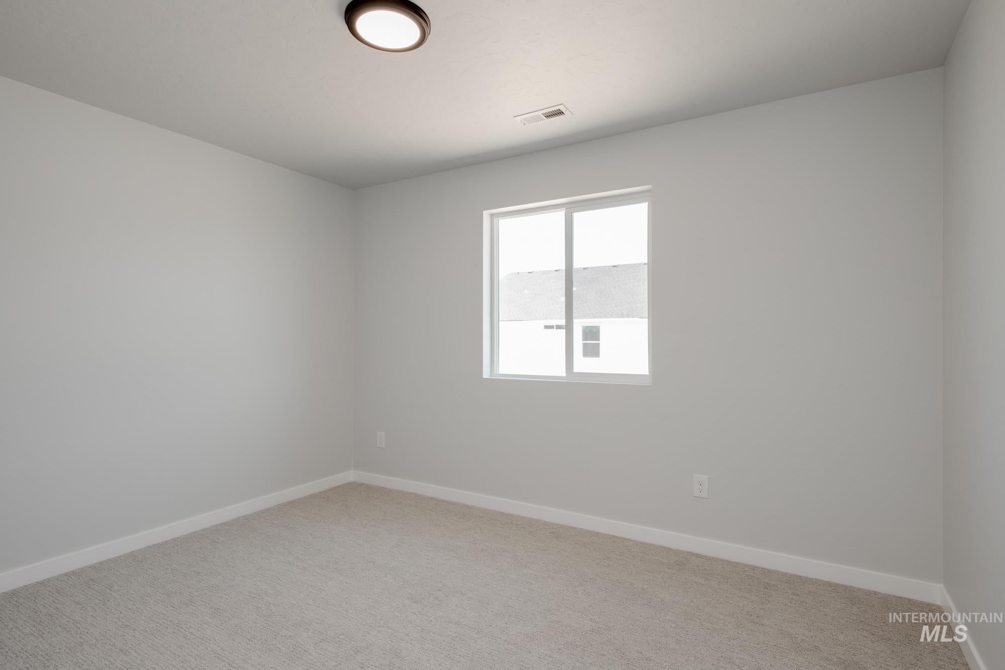 Empty room with baseboards and carpet floors