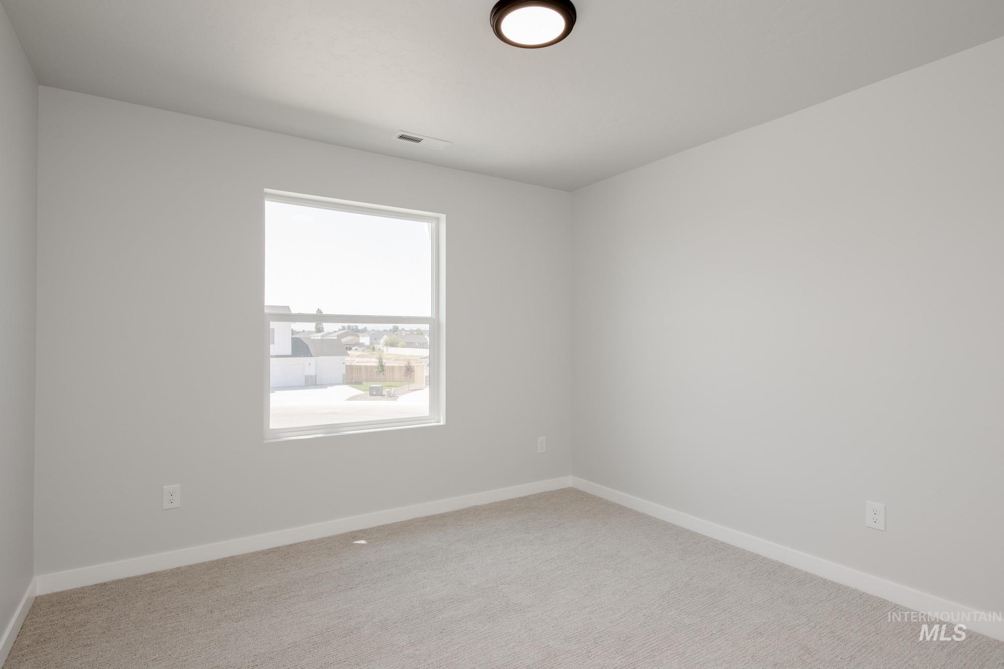 Empty room with baseboards and carpet floors
