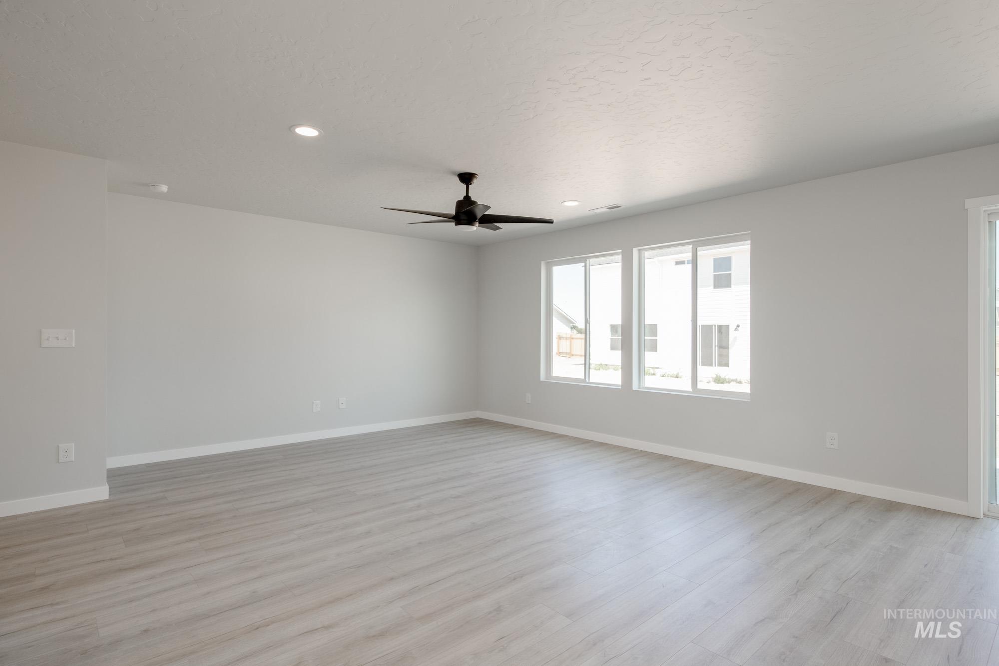Spare room featuring light wood finished floors, recessed lighting, and a ceiling fan