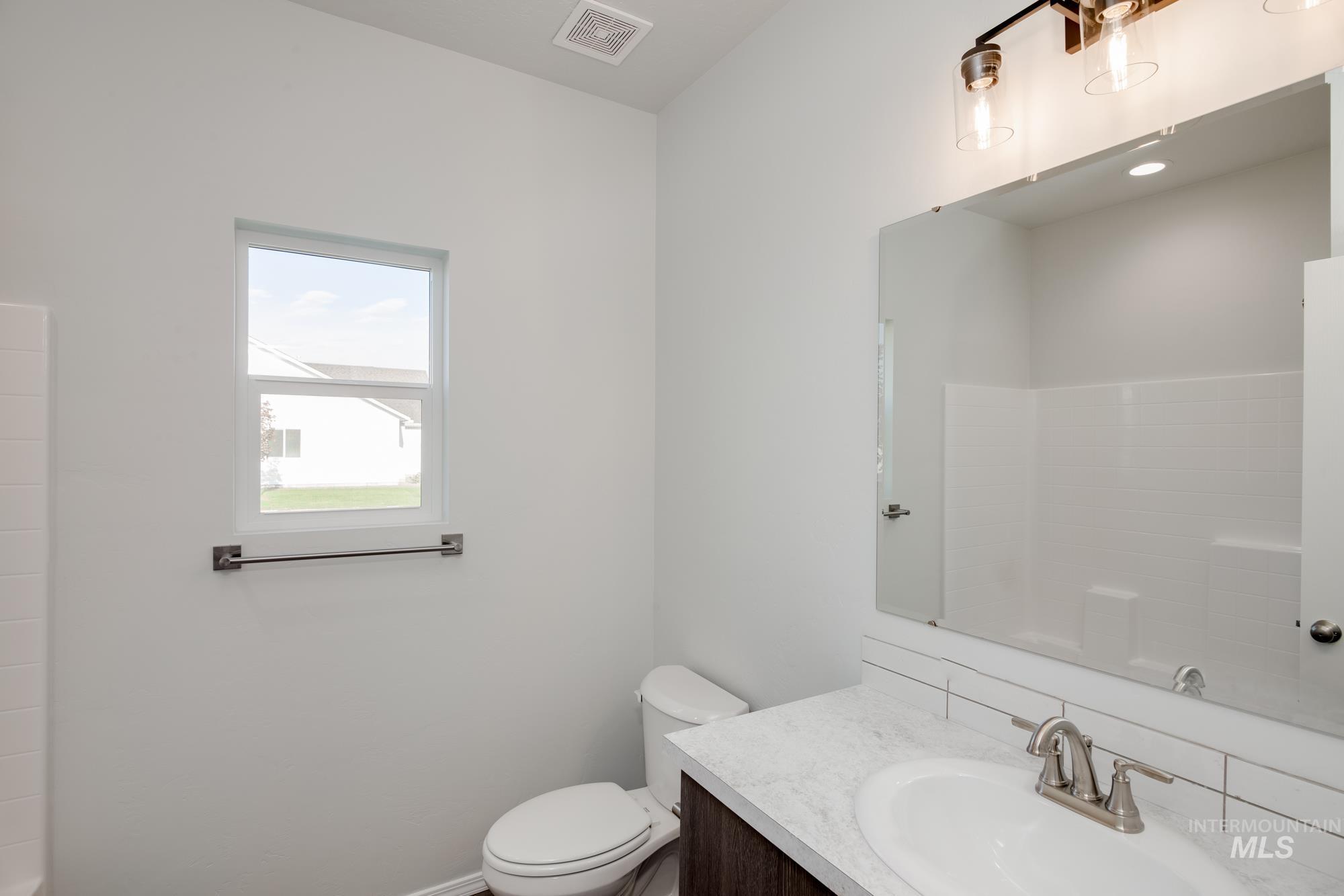 Full bathroom featuring vanity and toilet