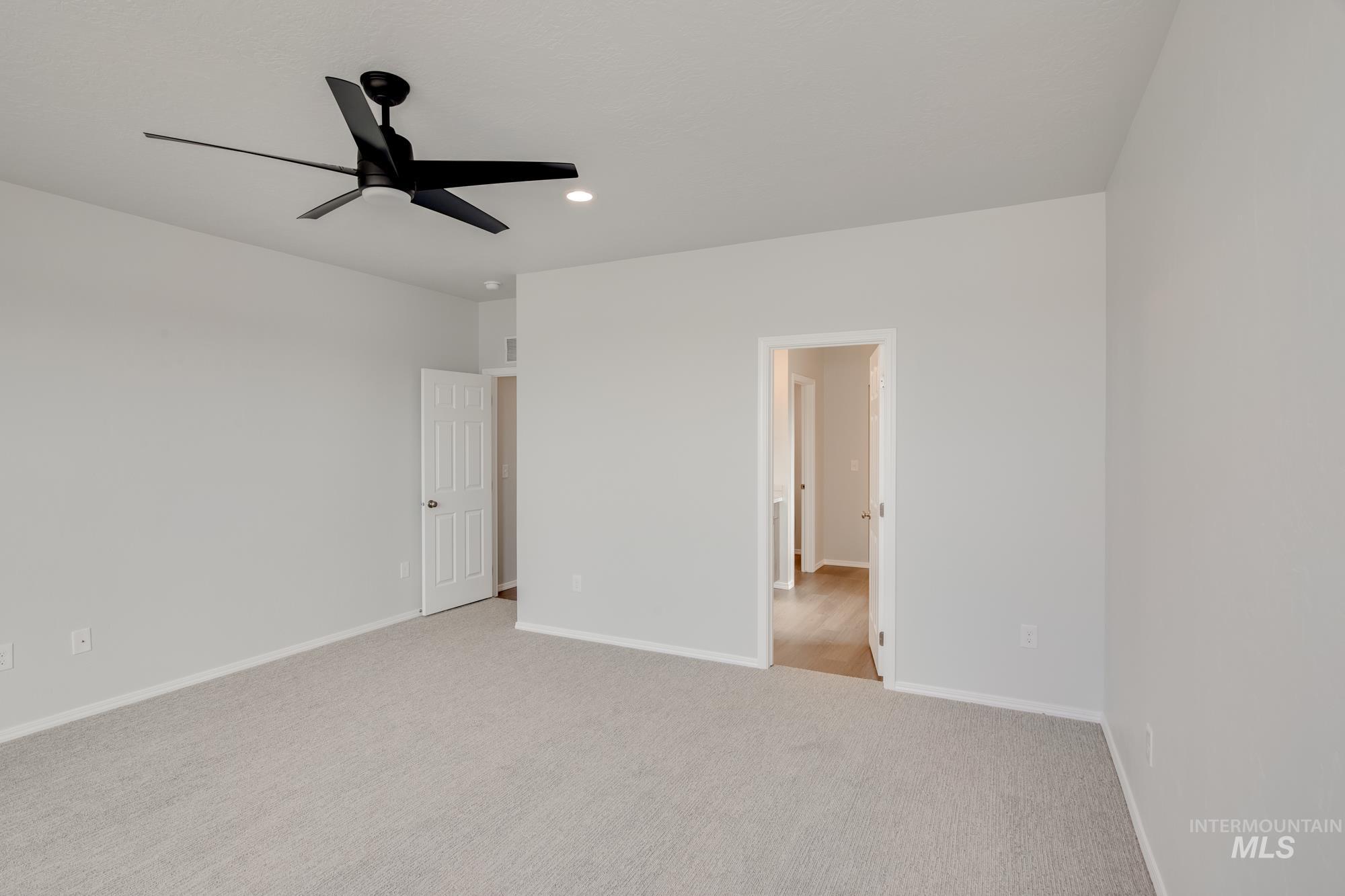 Unfurnished bedroom featuring carpet floors, ceiling fan, and recessed lighting