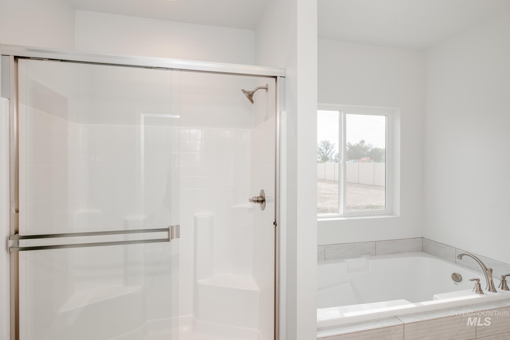 Bathroom with a bath and a stall shower