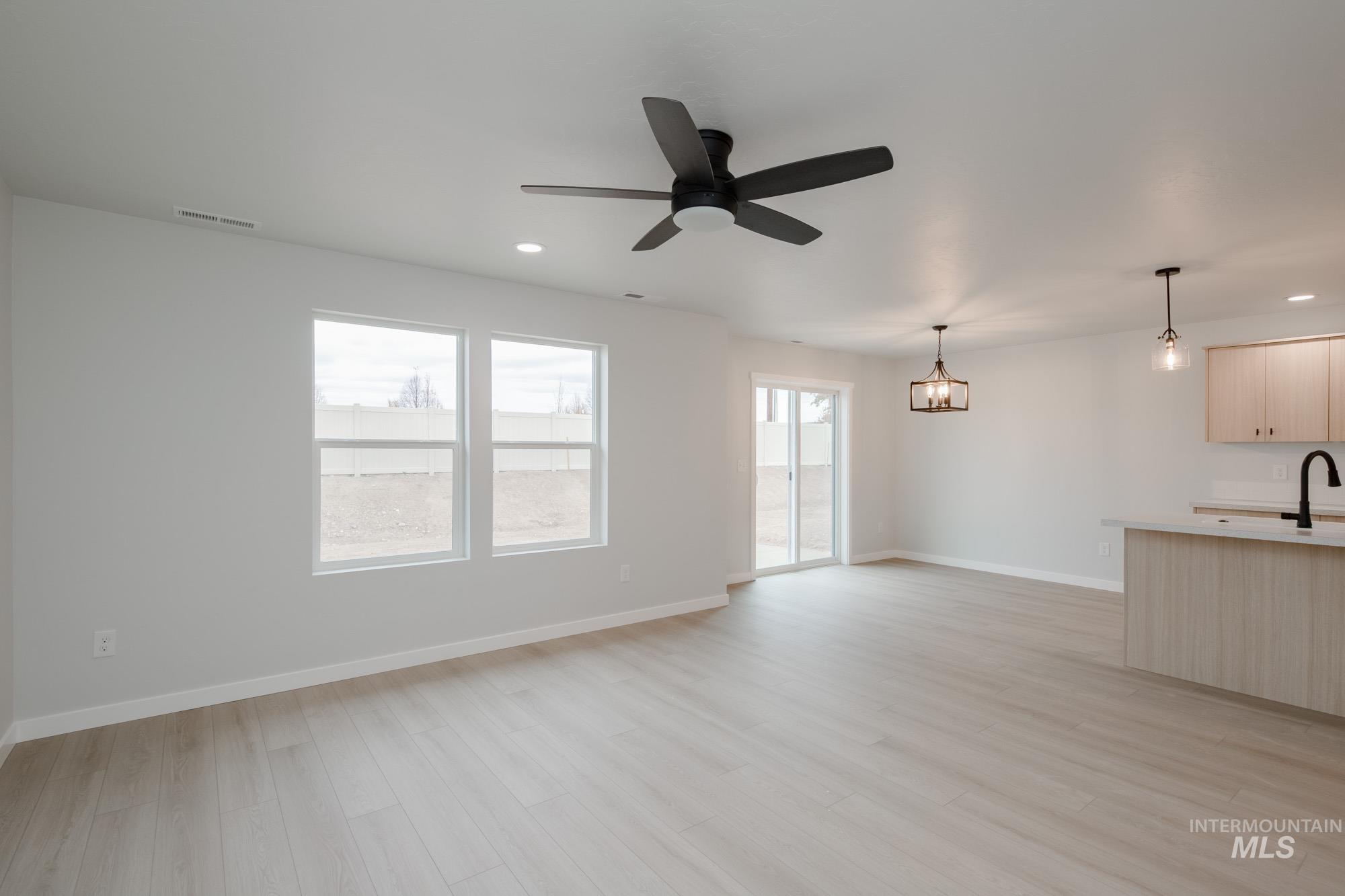 Unfurnished living room with recessed lighting, plenty of natural light, light wood-type flooring, and a ceiling fan