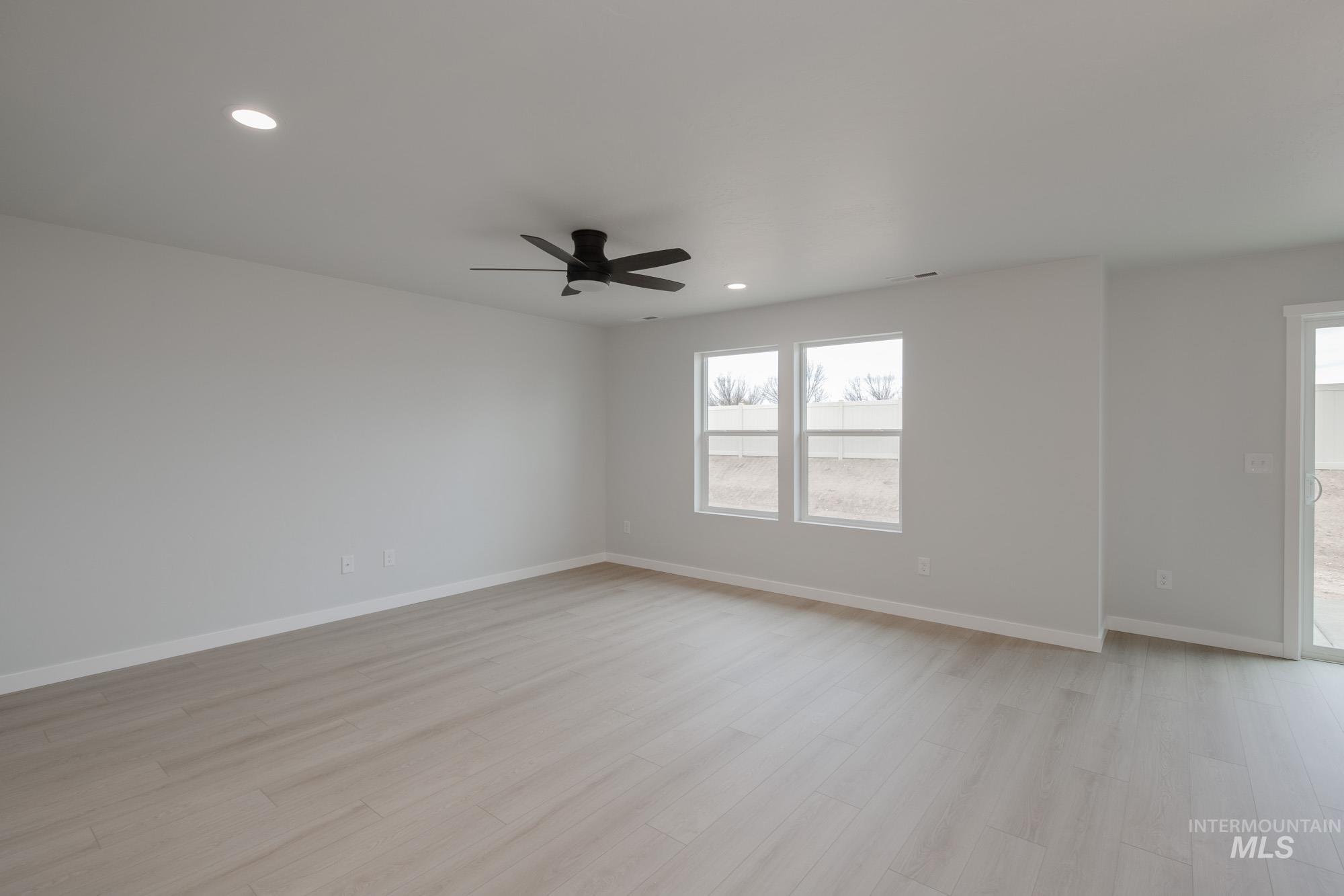 Spare room featuring light wood-style floors, recessed lighting, and a ceiling fan