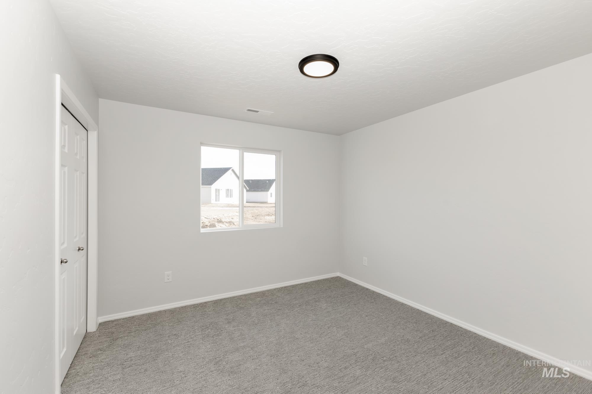 Unfurnished bedroom featuring a closet and carpet flooring