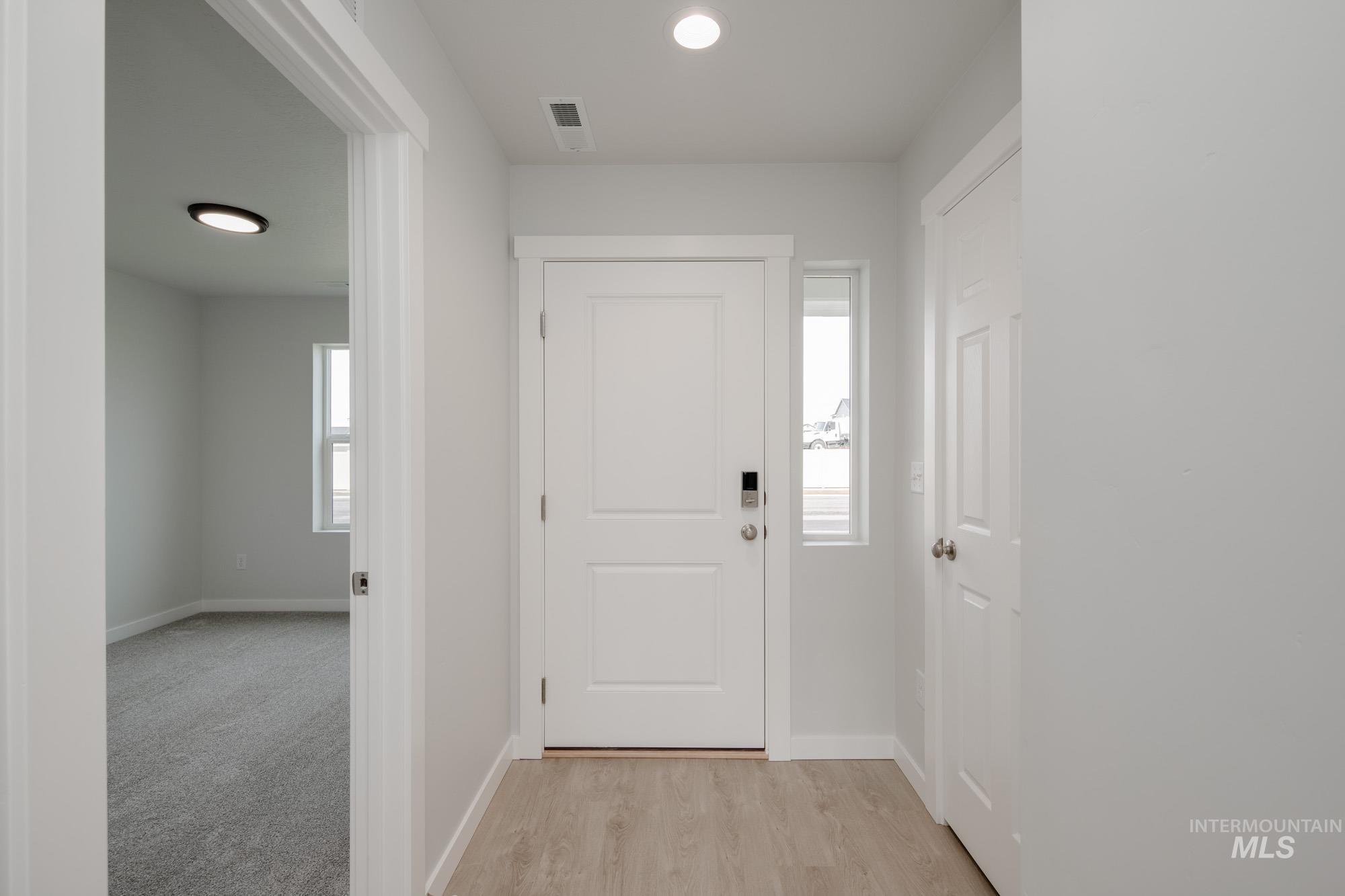 Foyer featuring baseboards and light wood-type flooring