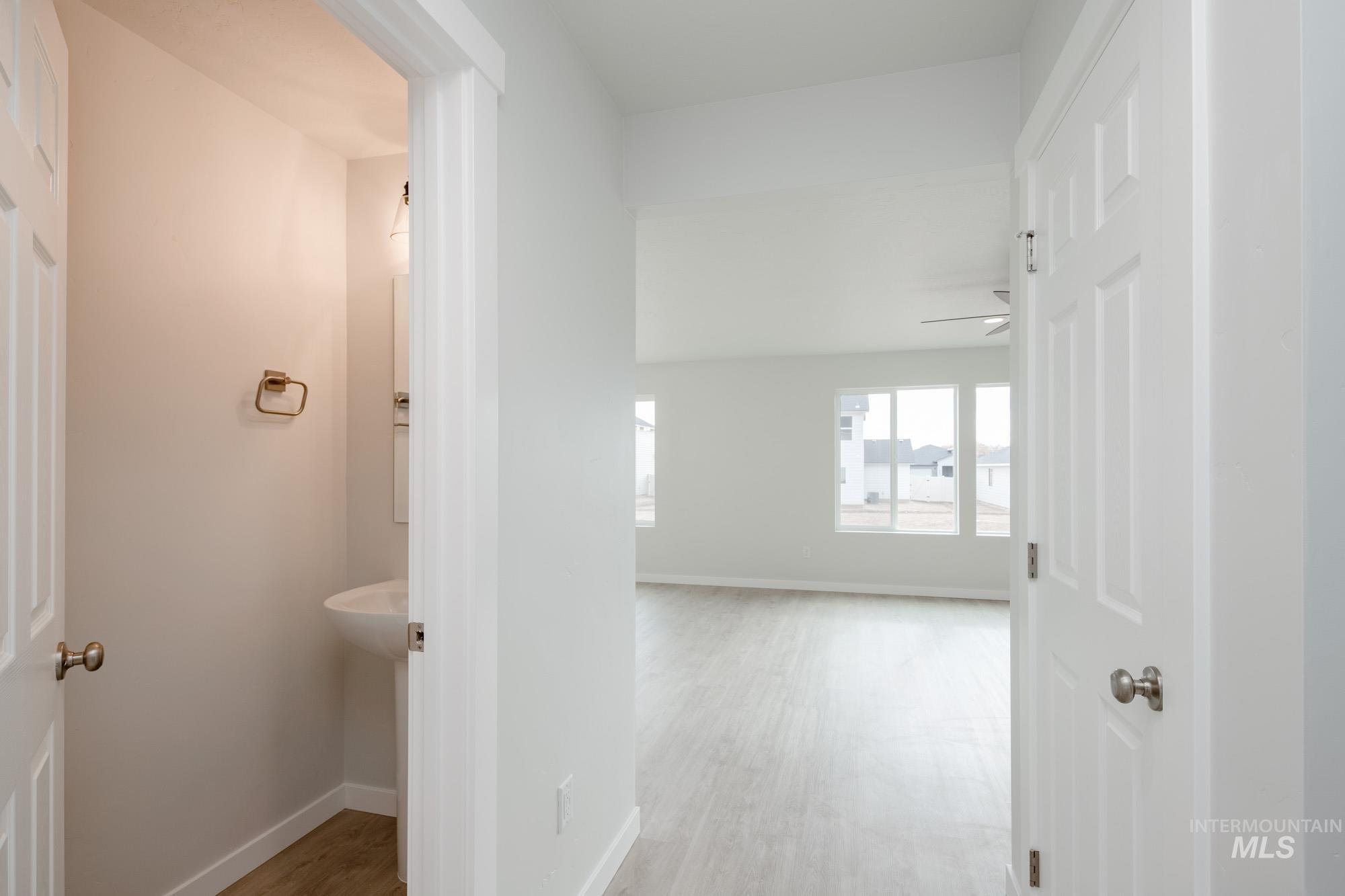Hall featuring light wood-type flooring and baseboards