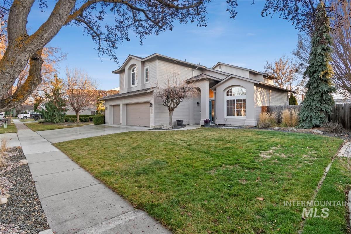 Traditional-style house with concrete driveway and an attached garage