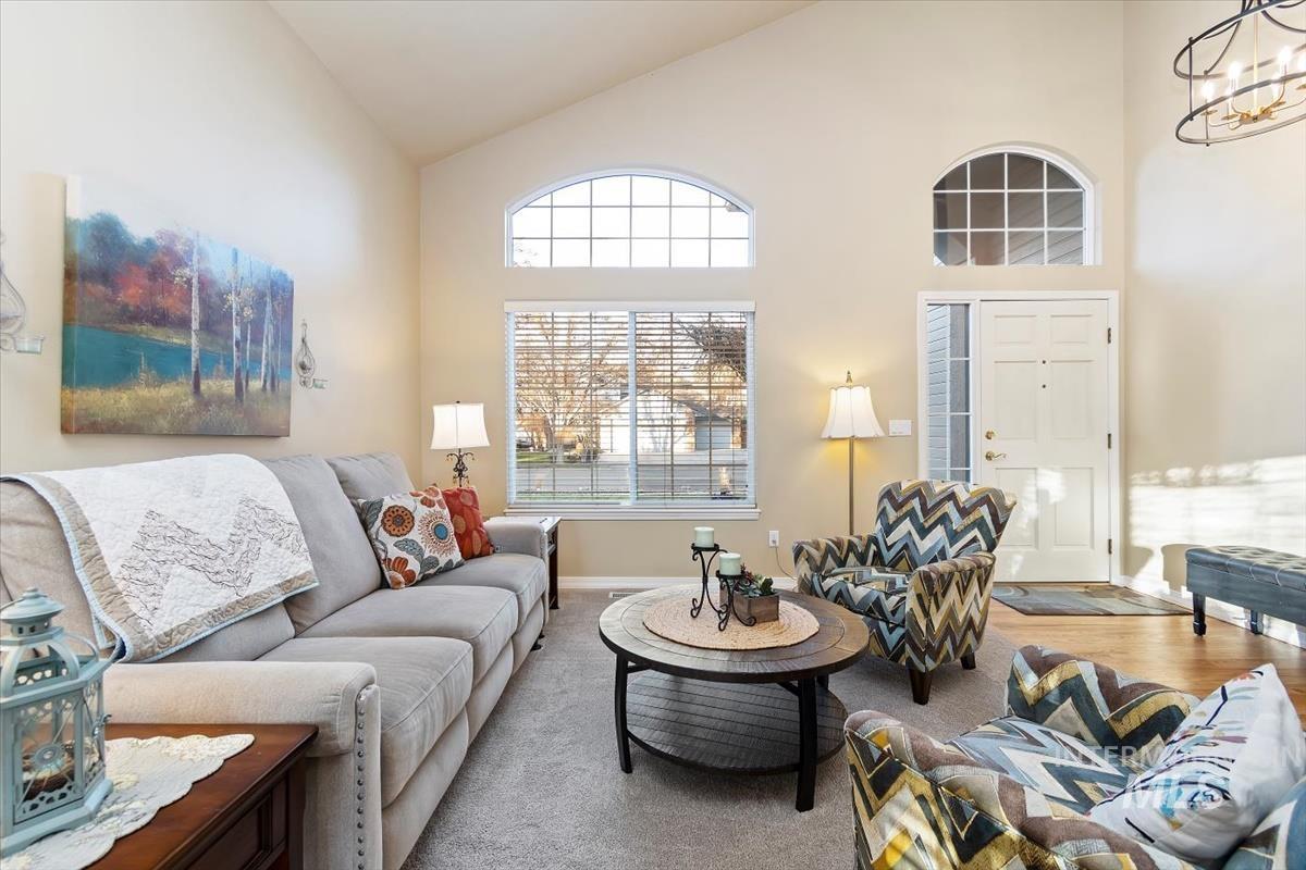 Living room with high vaulted ceiling and a chandelier