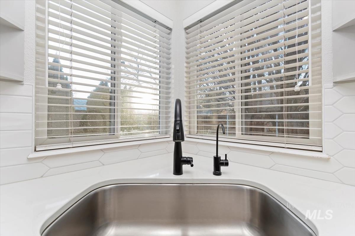 Kitchen view of light stone countertops and white cabinetry