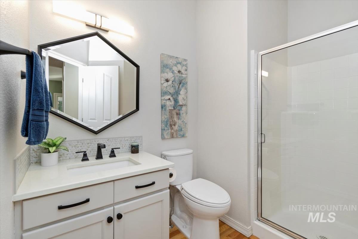 Bathroom featuring vanity and a stall shower