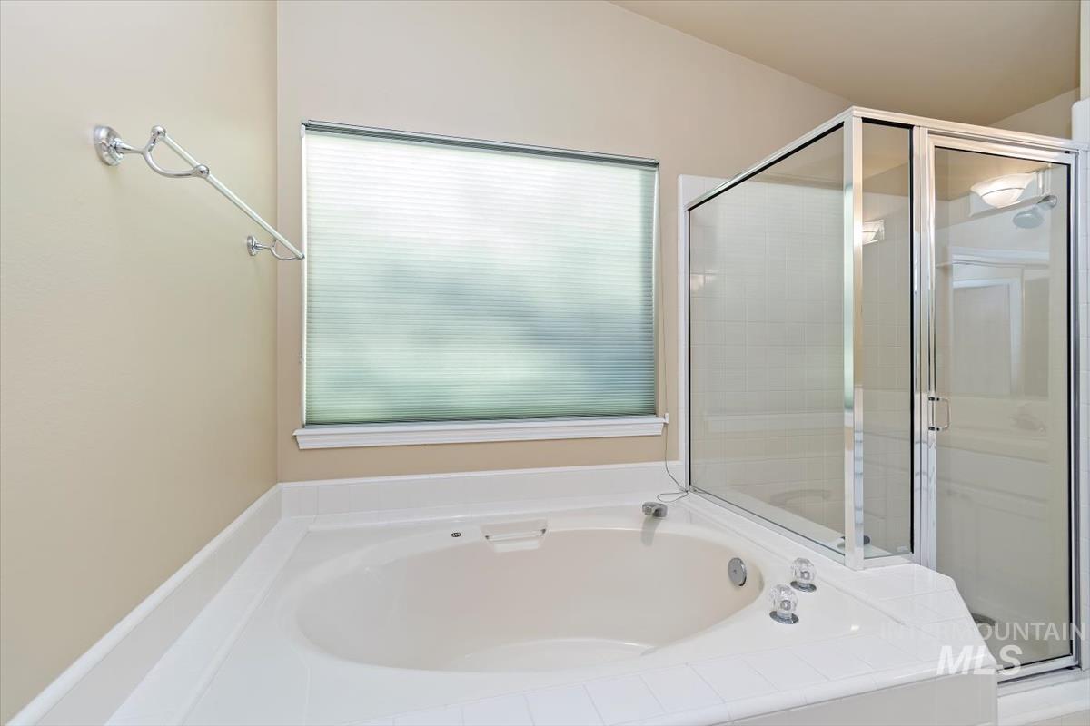 Full bath with a bath and a stall shower