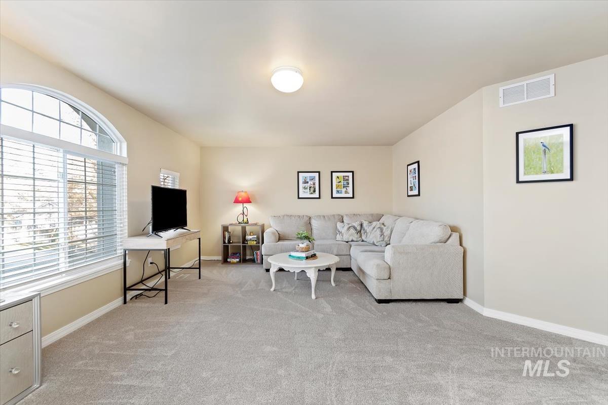 Living room with light carpet and baseboards