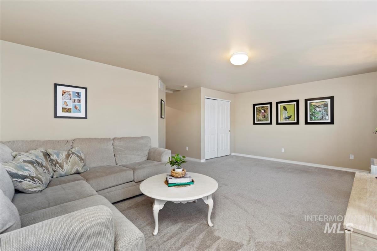 Carpeted living room featuring baseboards