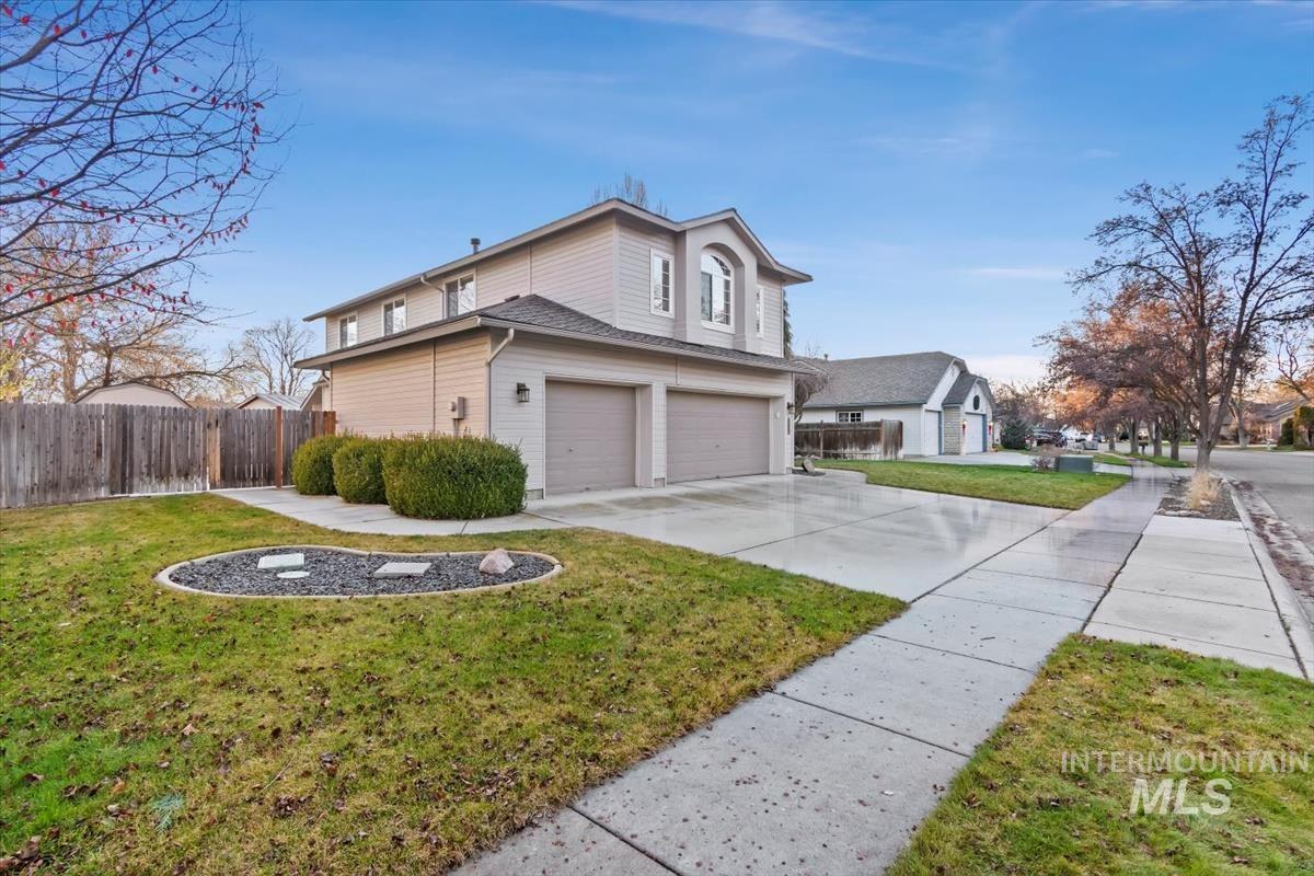 View of side of home featuring concrete driveway and a garage