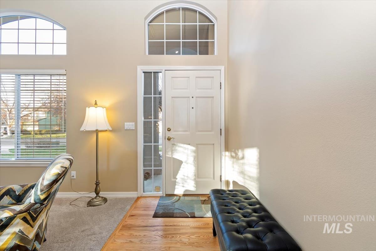 Foyer with carpet and a high ceiling