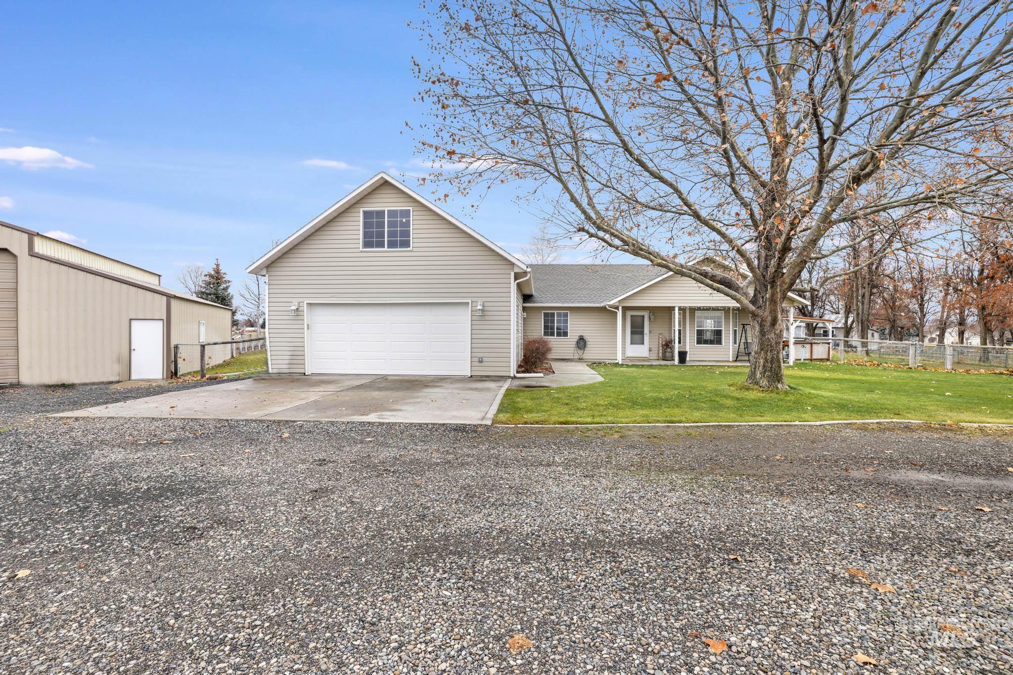 View of front of home with driveway and a garage