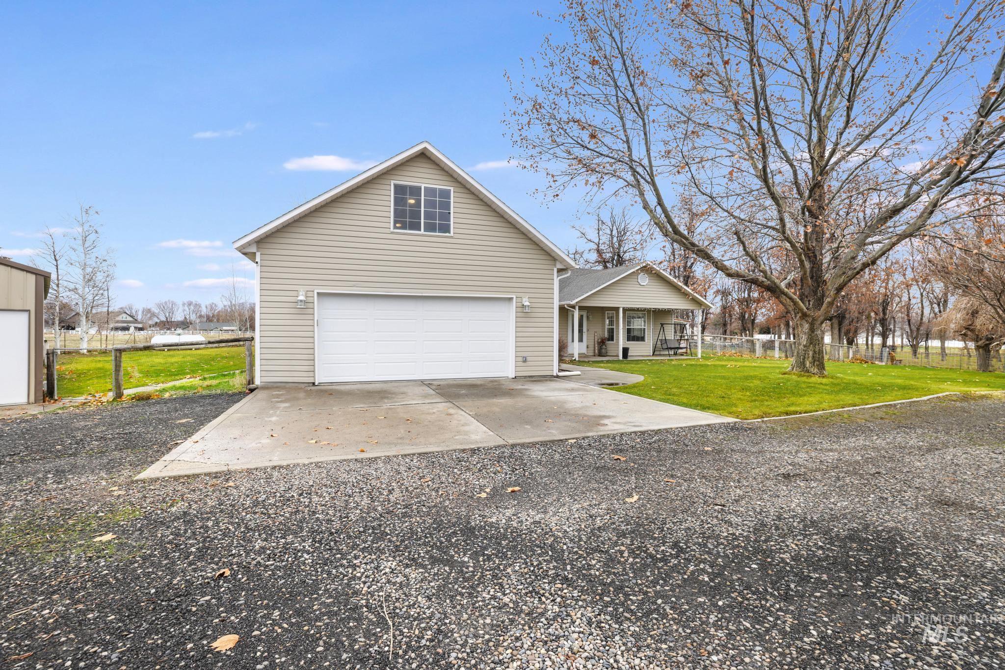 View of front of property featuring driveway and a porch