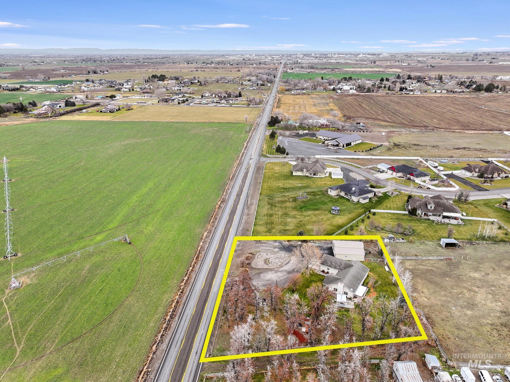 Aerial view of sparsely populated area featuring property parcel outlined and abundant farmland