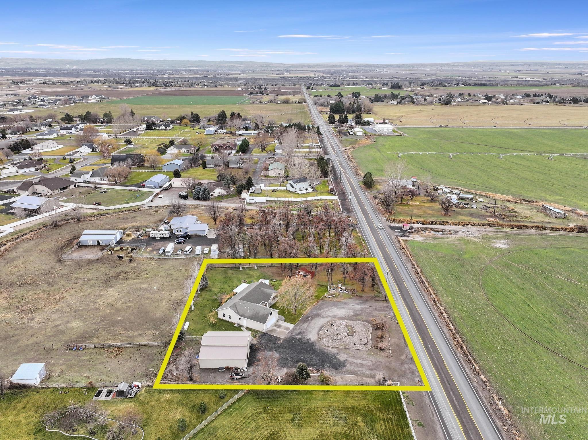 Aerial view of sparsely populated area with property parcel outlined